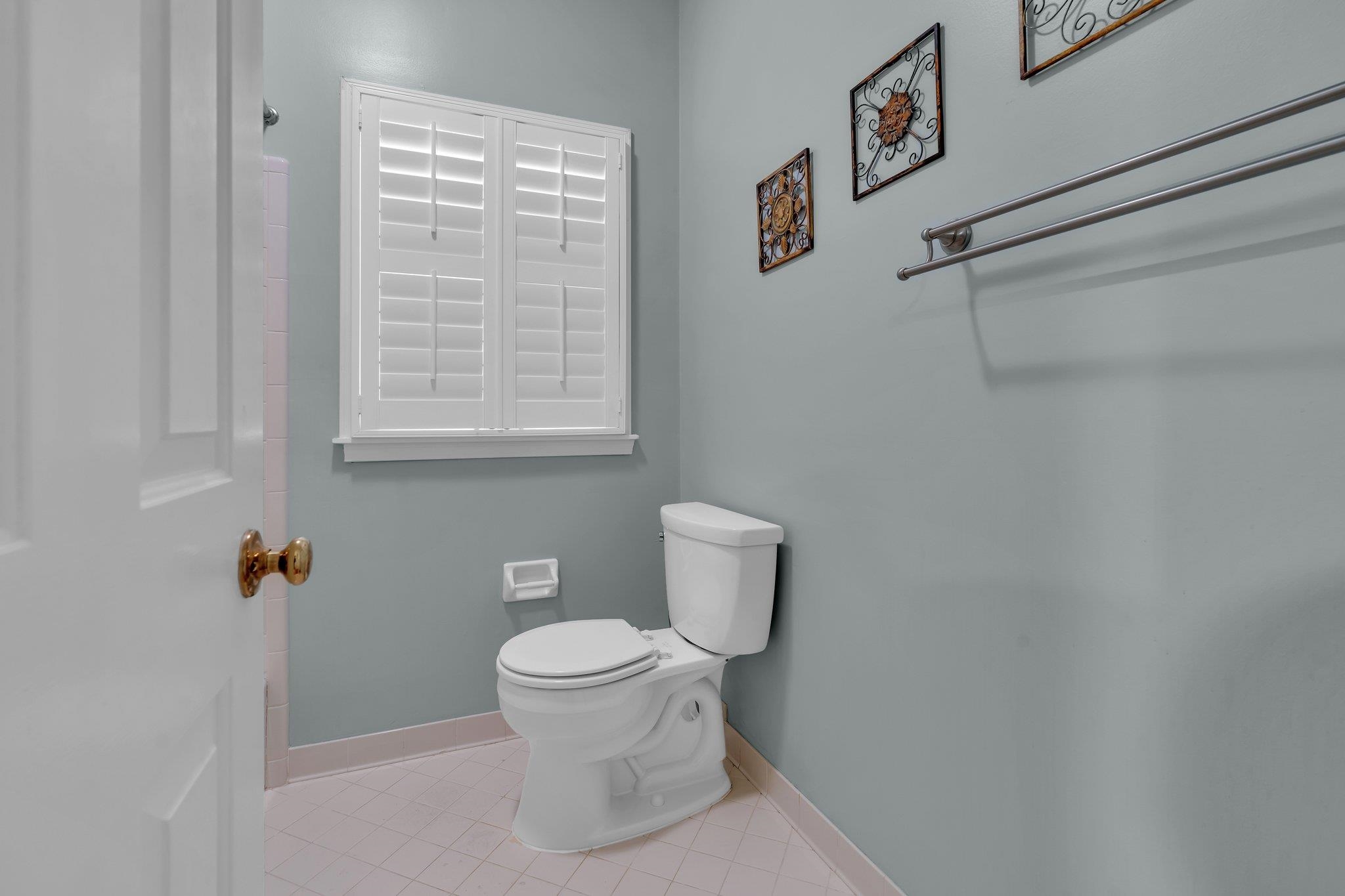 Bathroom featuring tile patterned flooring and toilet