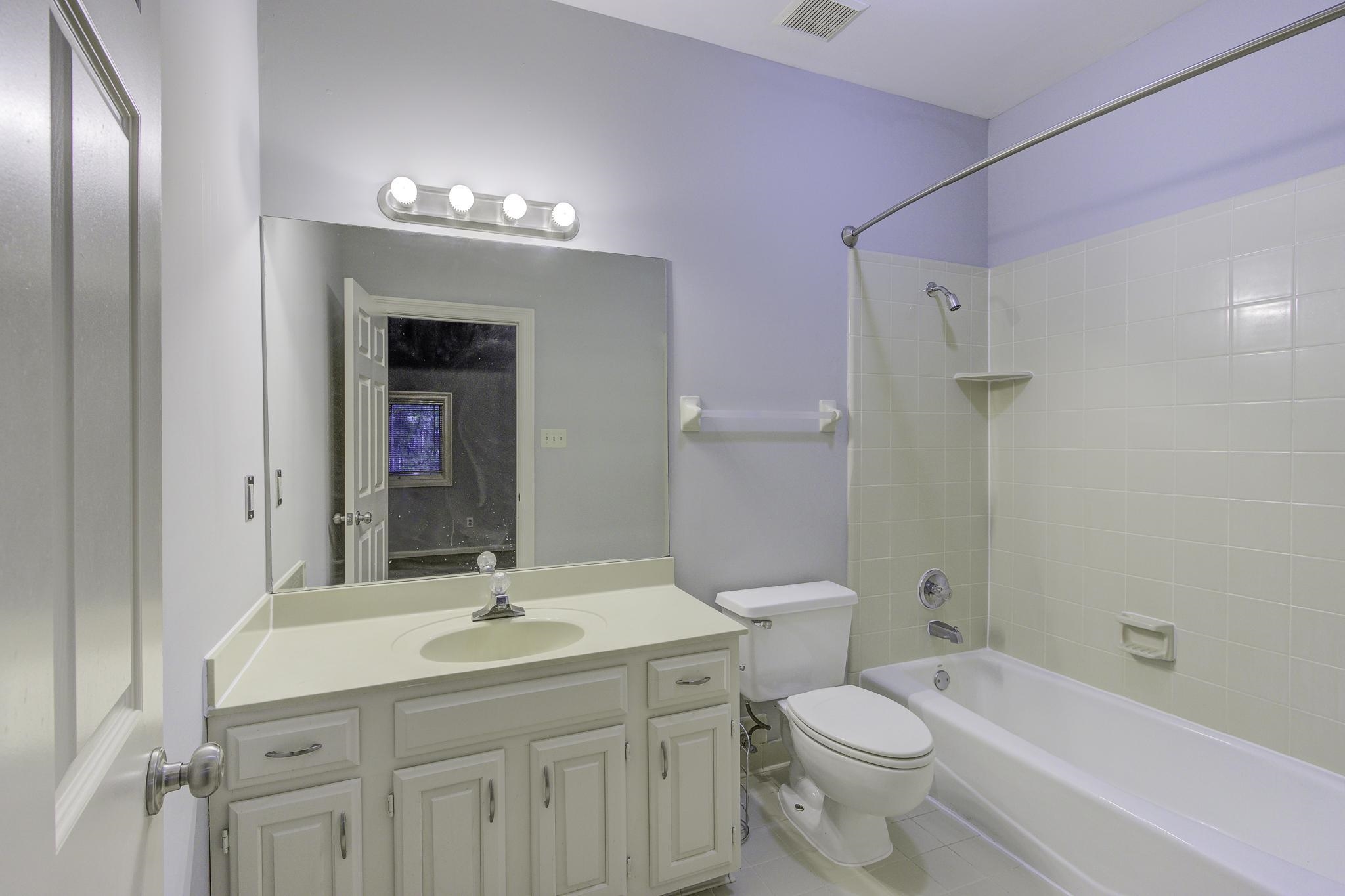 The south side ensuite also enjoys it\'s own full bath - complete with a tub/shower, single vanity, and tile flooring.