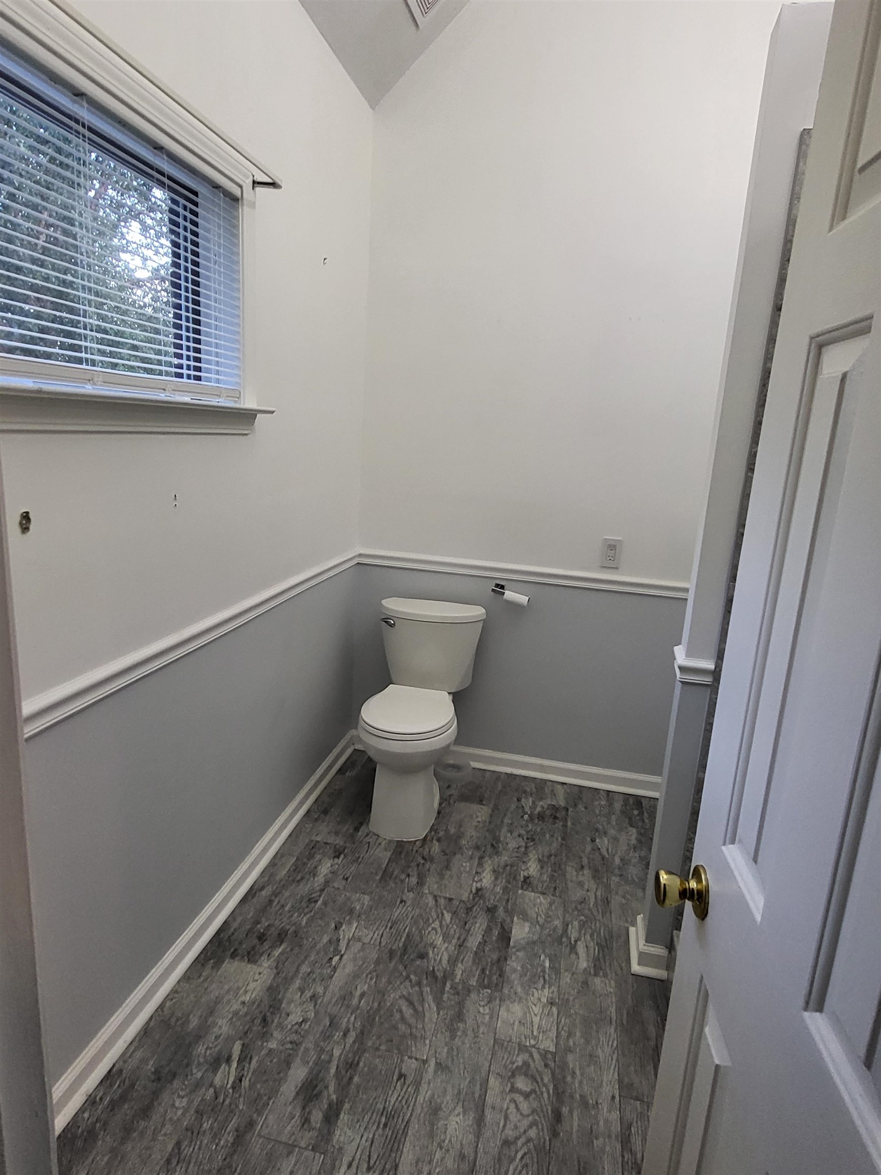 Bathroom featuring toilet and hardwood / wood-style floors
