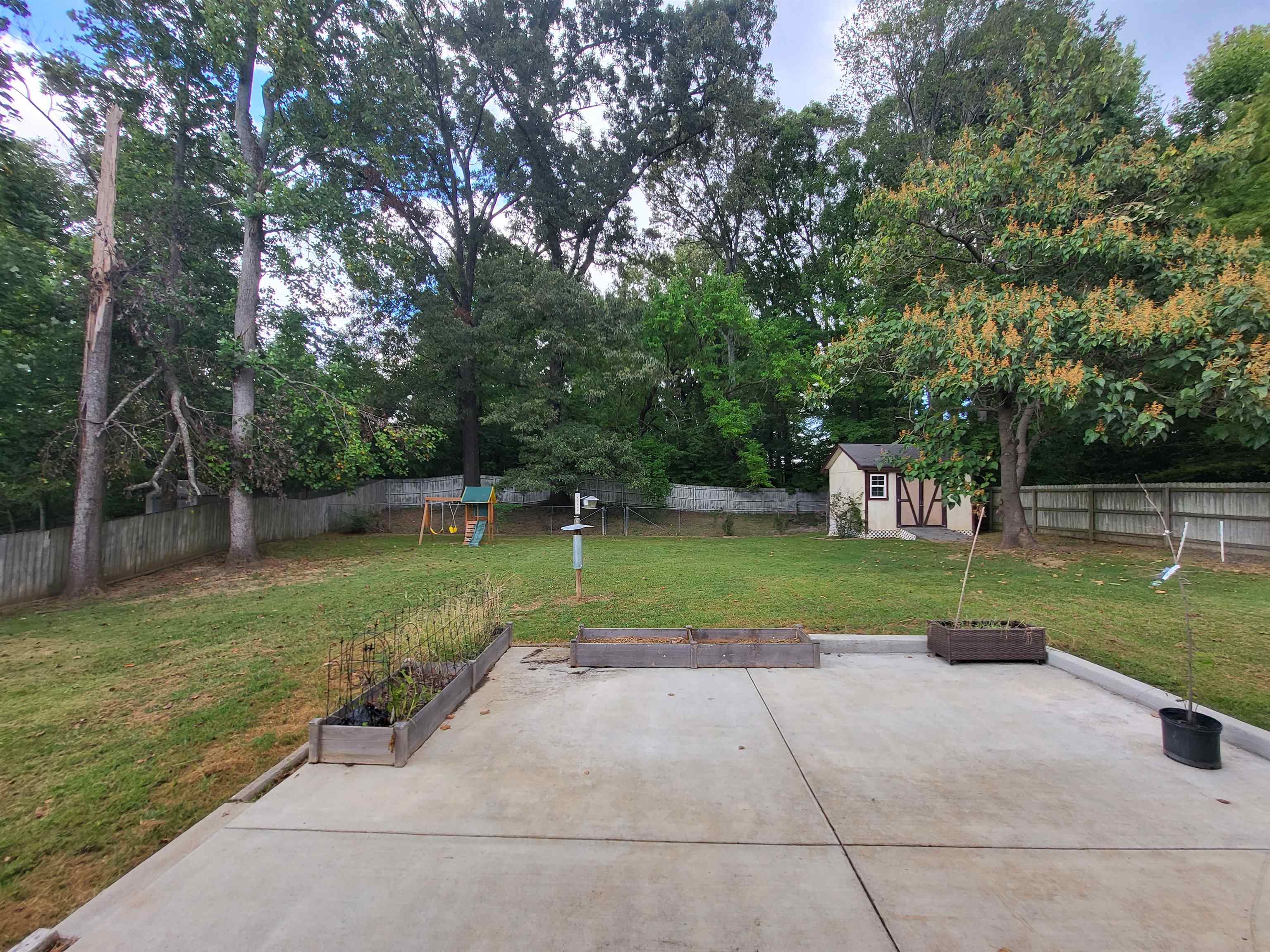 View of patio featuring a shed
