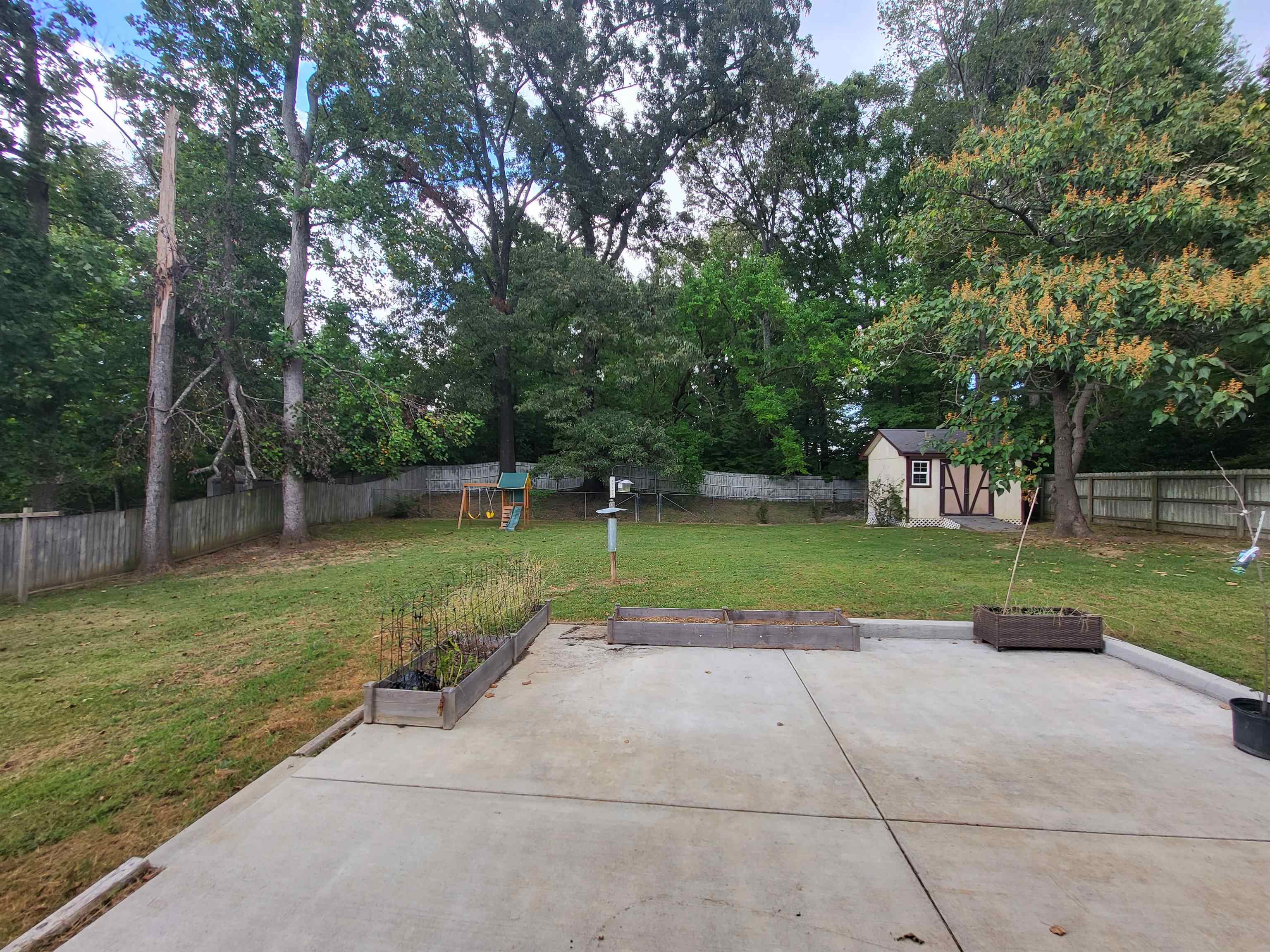 View of patio / terrace featuring a storage shed
