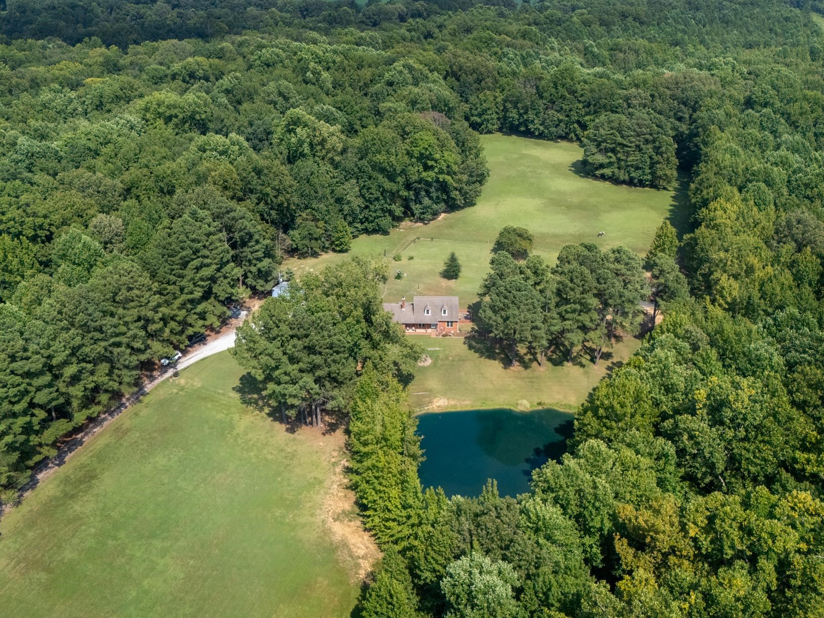 Birds eye view of property with a water view