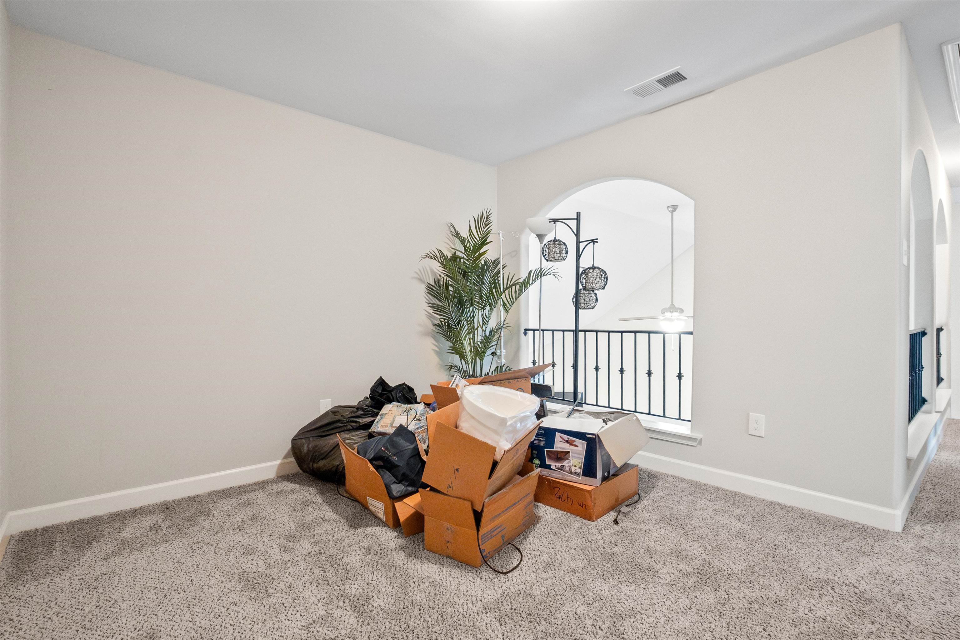 Interior space with ceiling fan and carpet floors