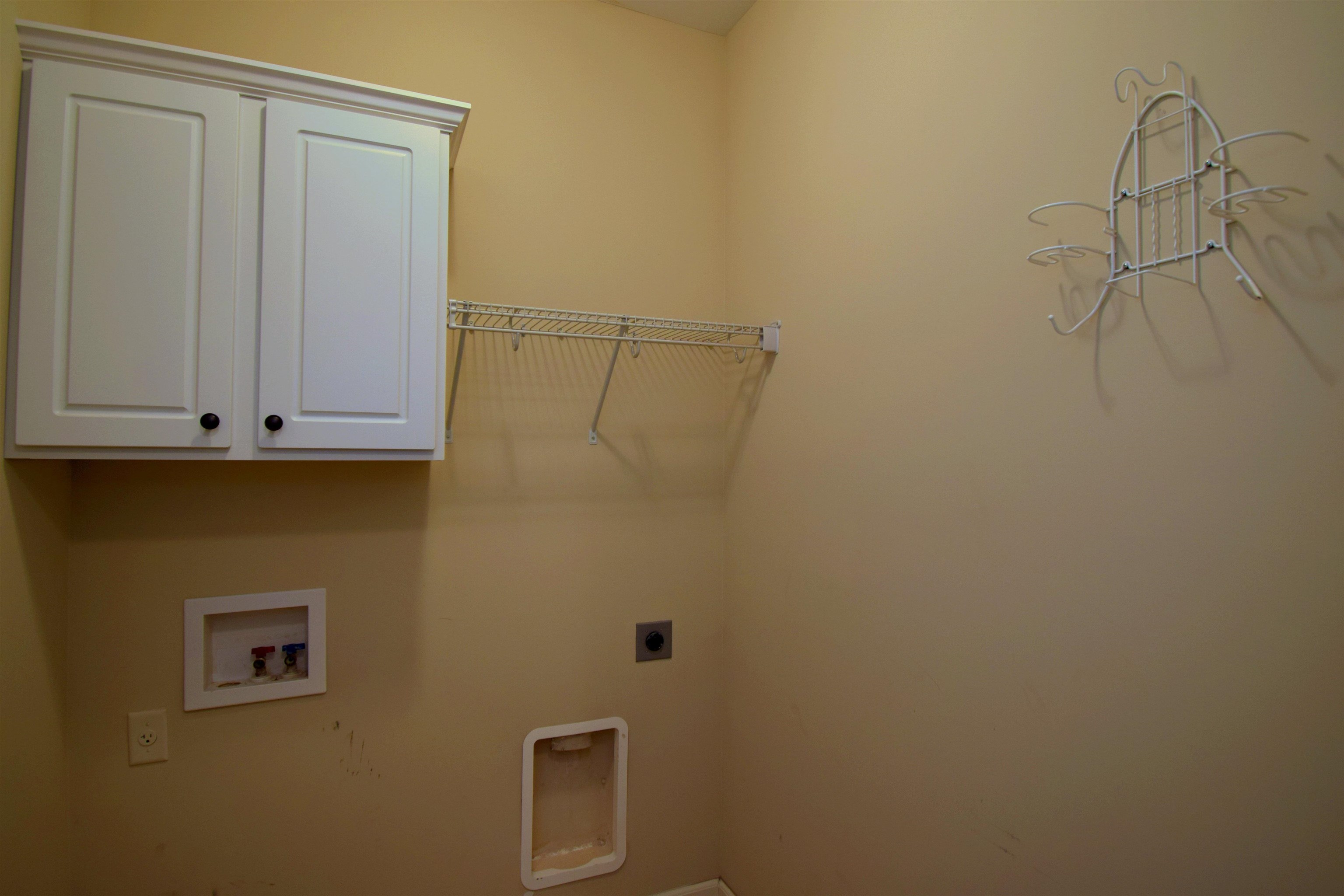 Laundry room featuring washer hookup, cabinets, and electric dryer hookup