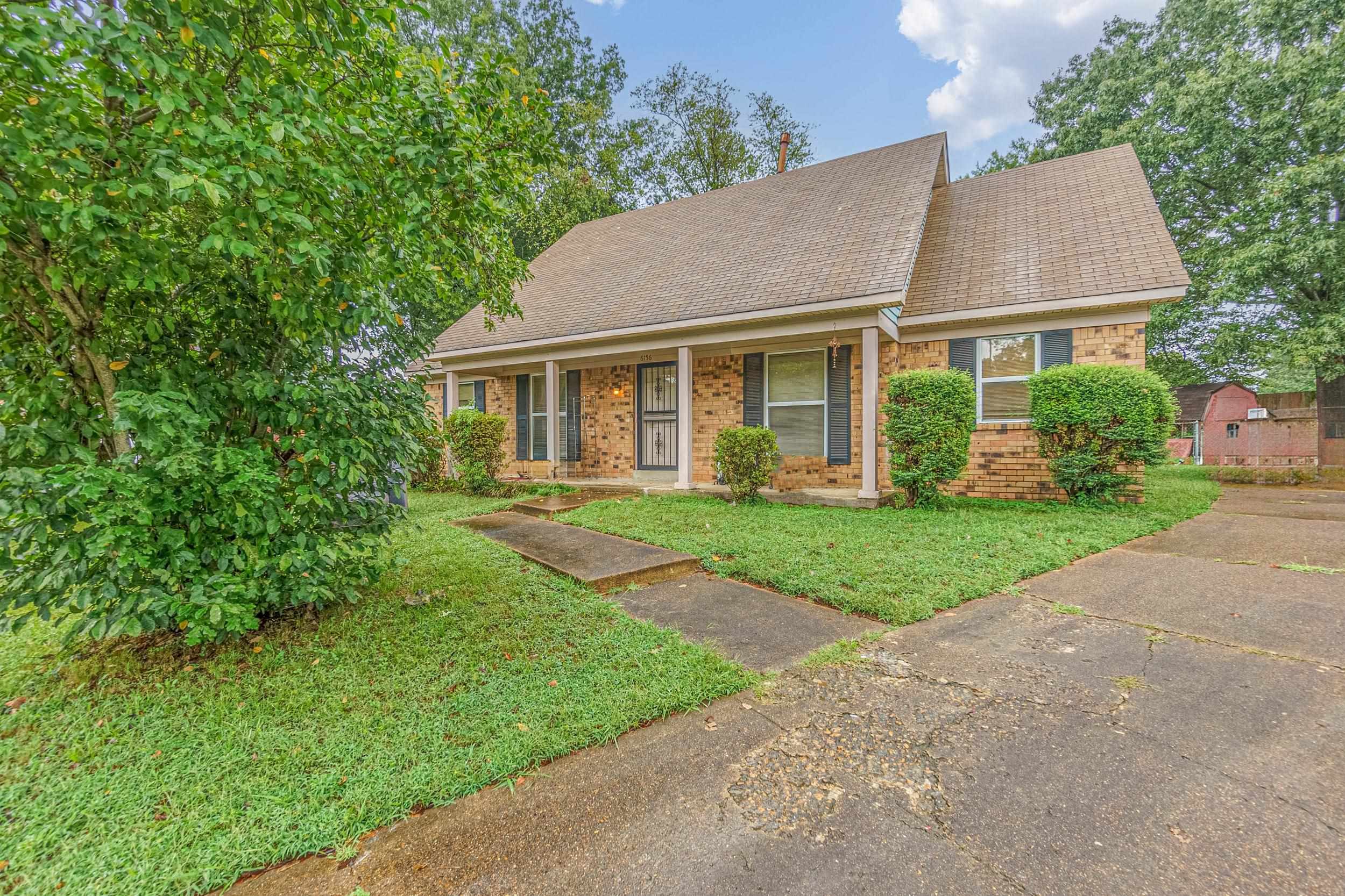 View of front of house with a front yard and a porch