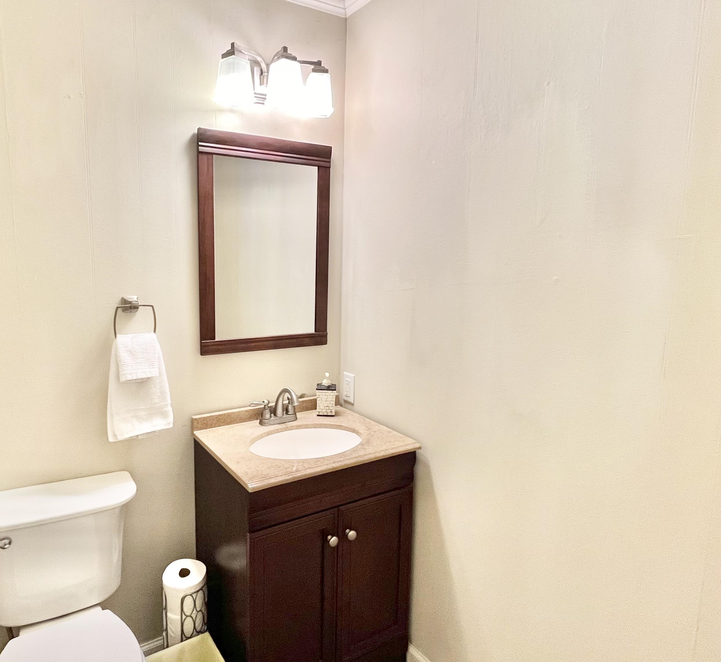 Bathroom with vanity and toilet as you come in from the garage.