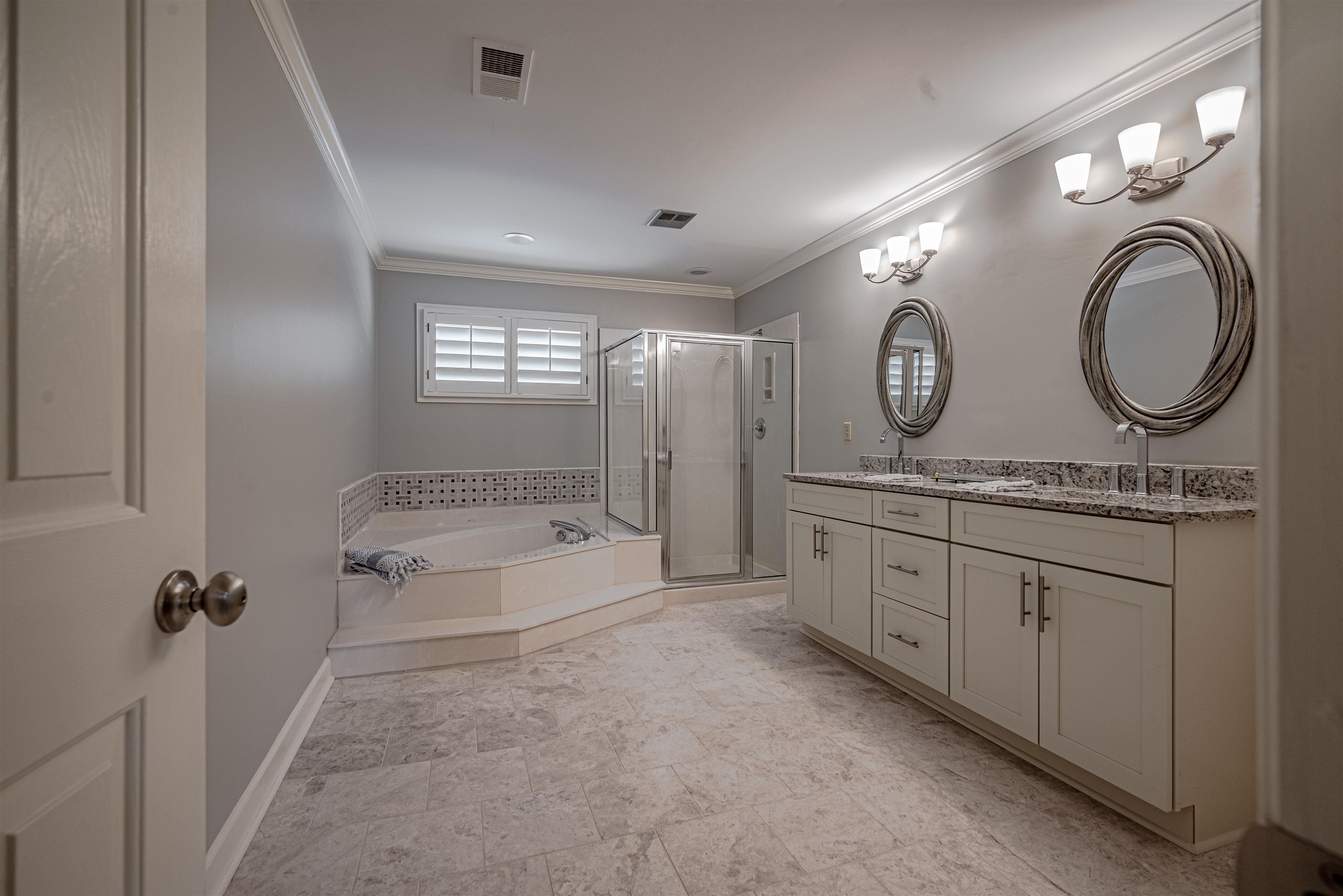 Bathroom featuring ornamental molding, vanity, and shower with separate bathtub