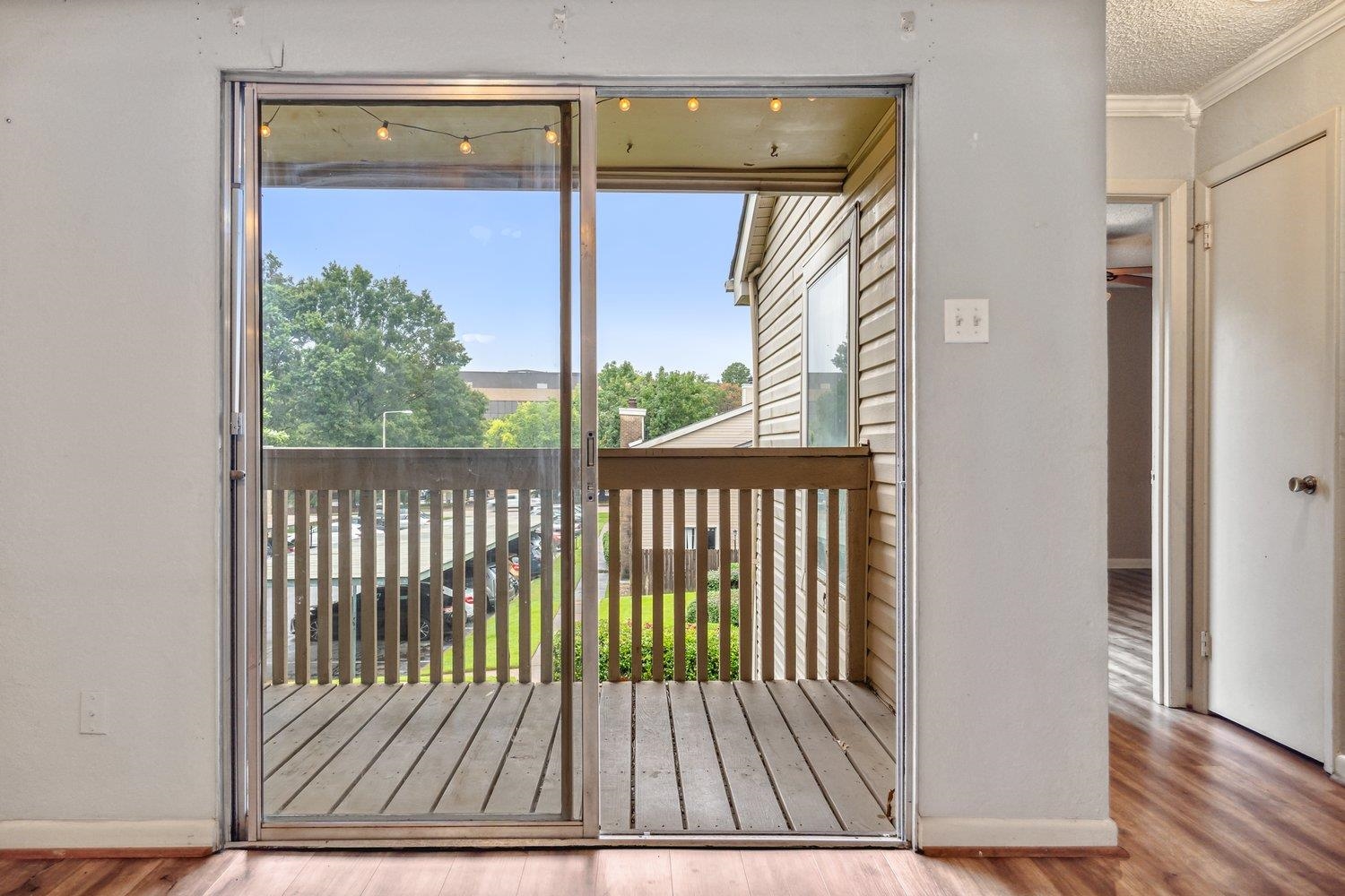 Doorway to outside with ornamental molding, wood-type flooring, and a wealth of natural light