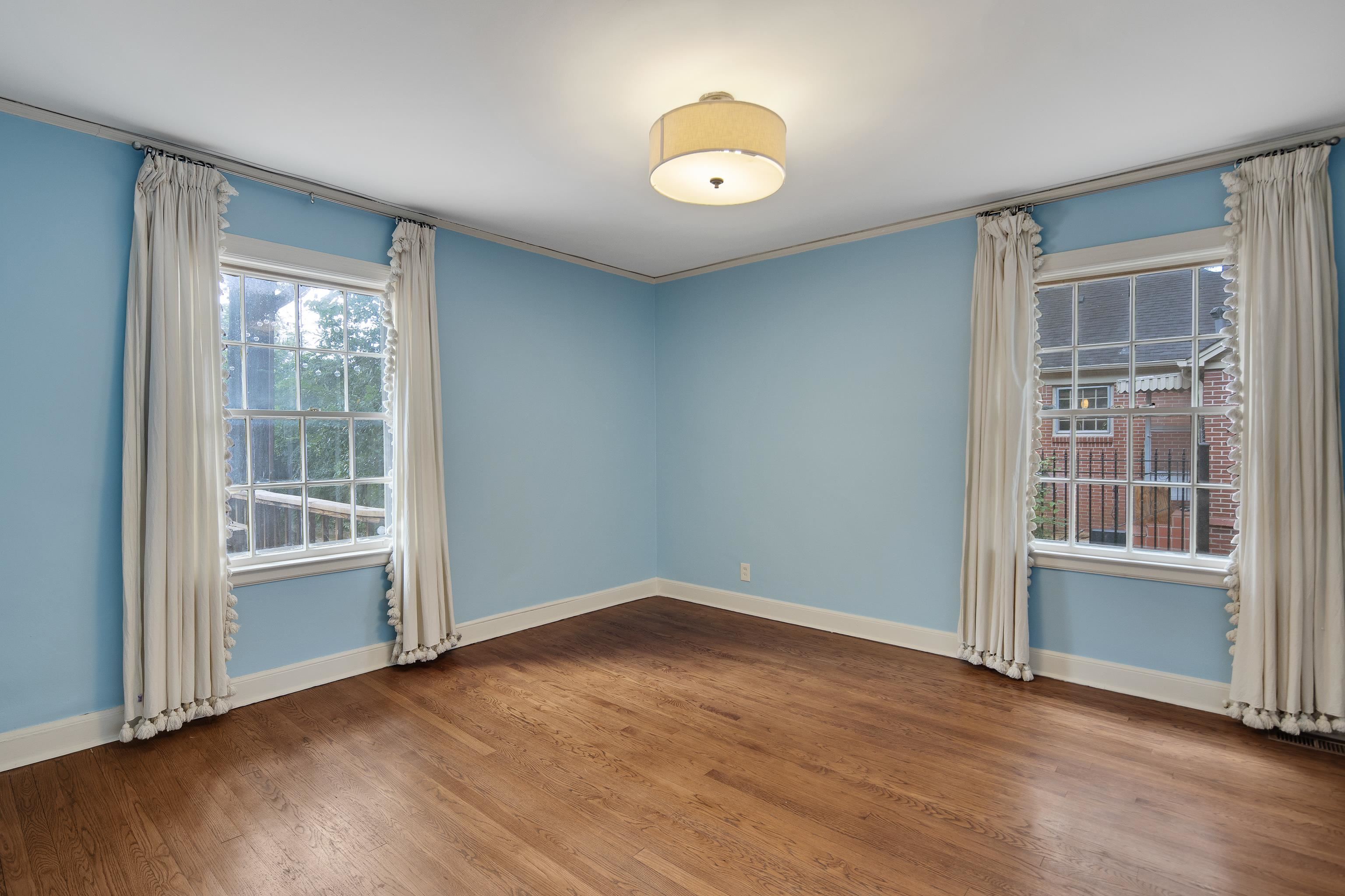 Spare room featuring ornamental molding and wood-type flooring