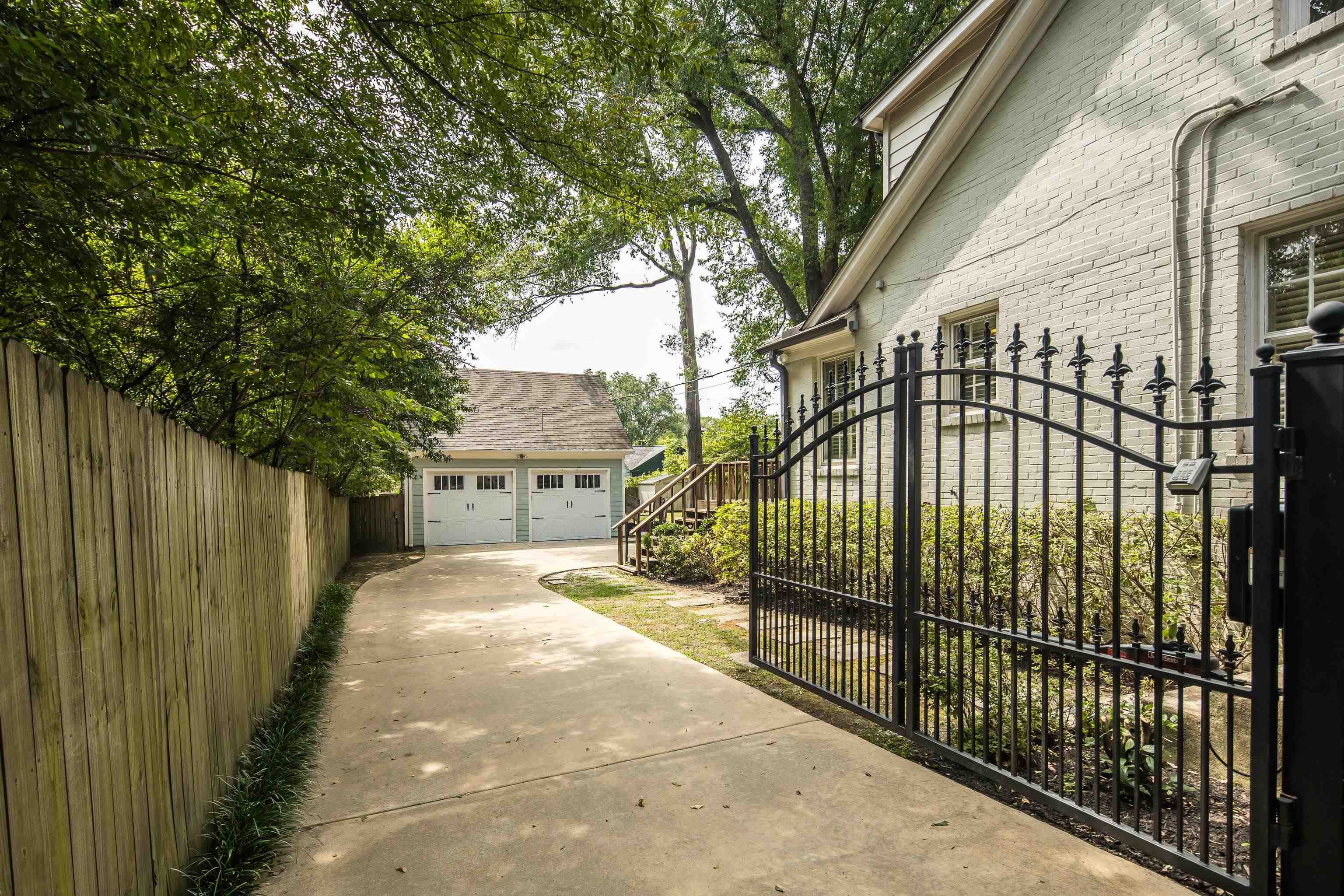 View of side of home featuring an outbuilding and a garage