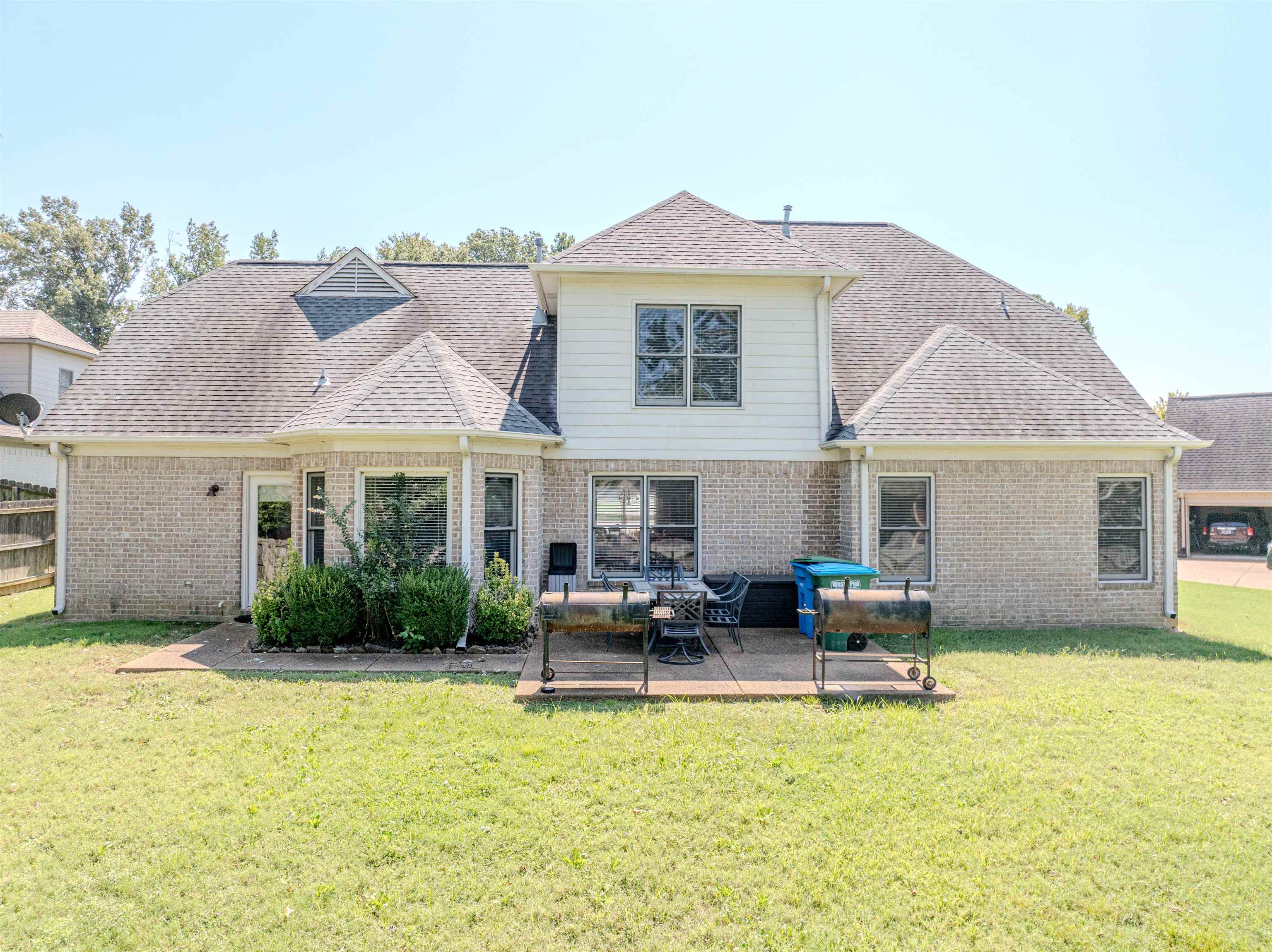 Rear view of house featuring a lawn and a patio area