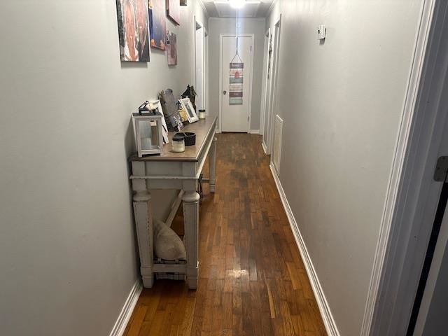 Corridor featuring dark hardwood / wood-style floors