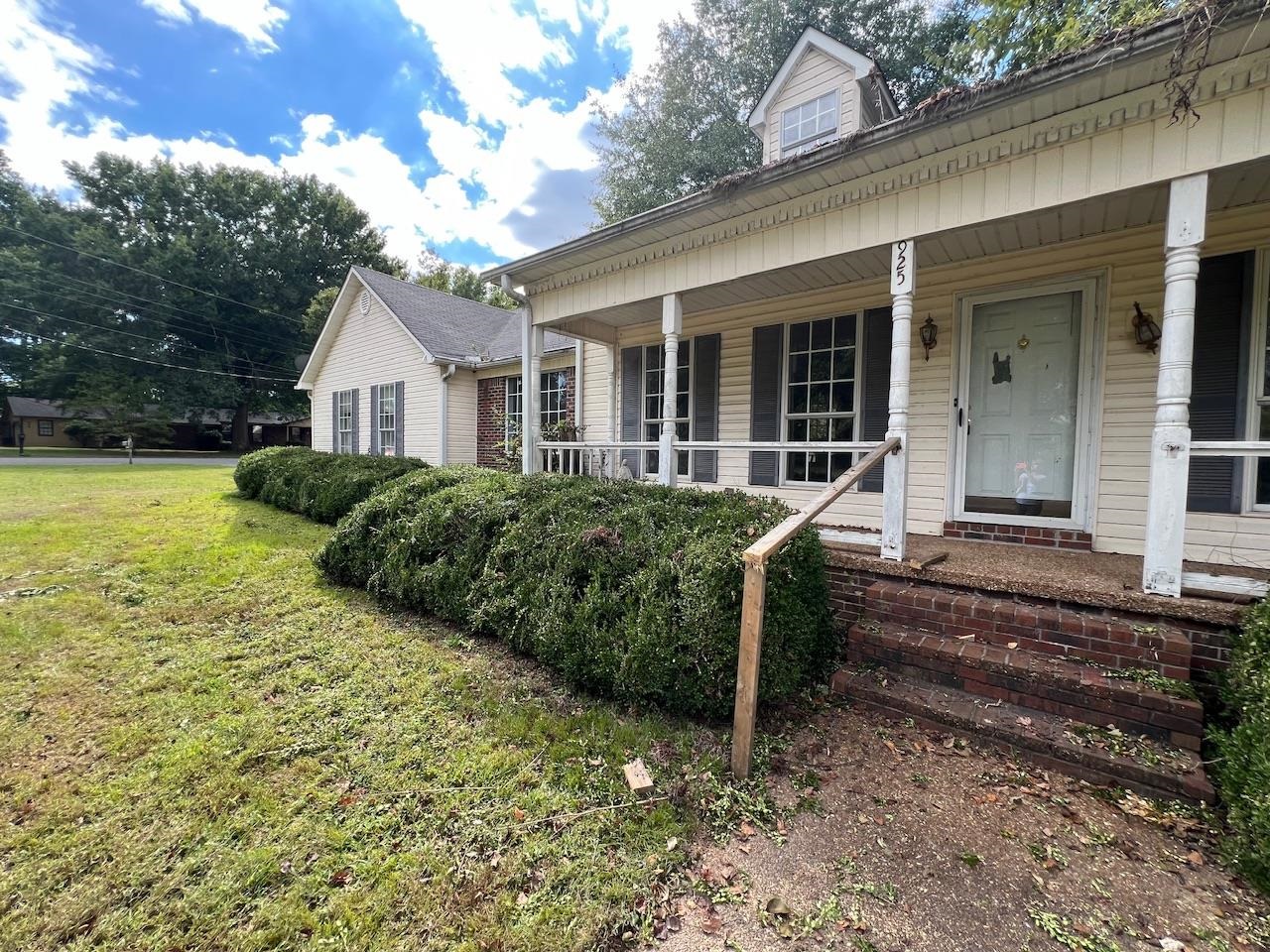 Exterior space featuring a yard and covered porch