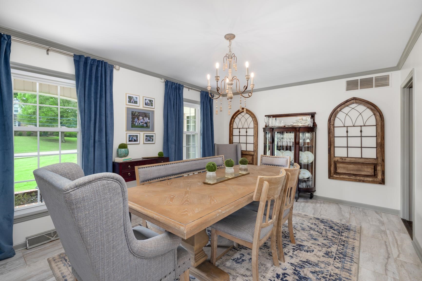 Dining space featuring a notable chandelier, plenty of natural light, and ornamental molding