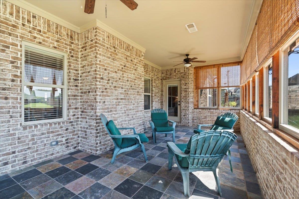 View of patio featuring ceiling fan