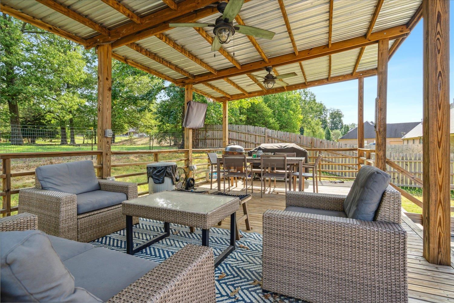 Wooden terrace with ceiling fan and an outdoor hangout area