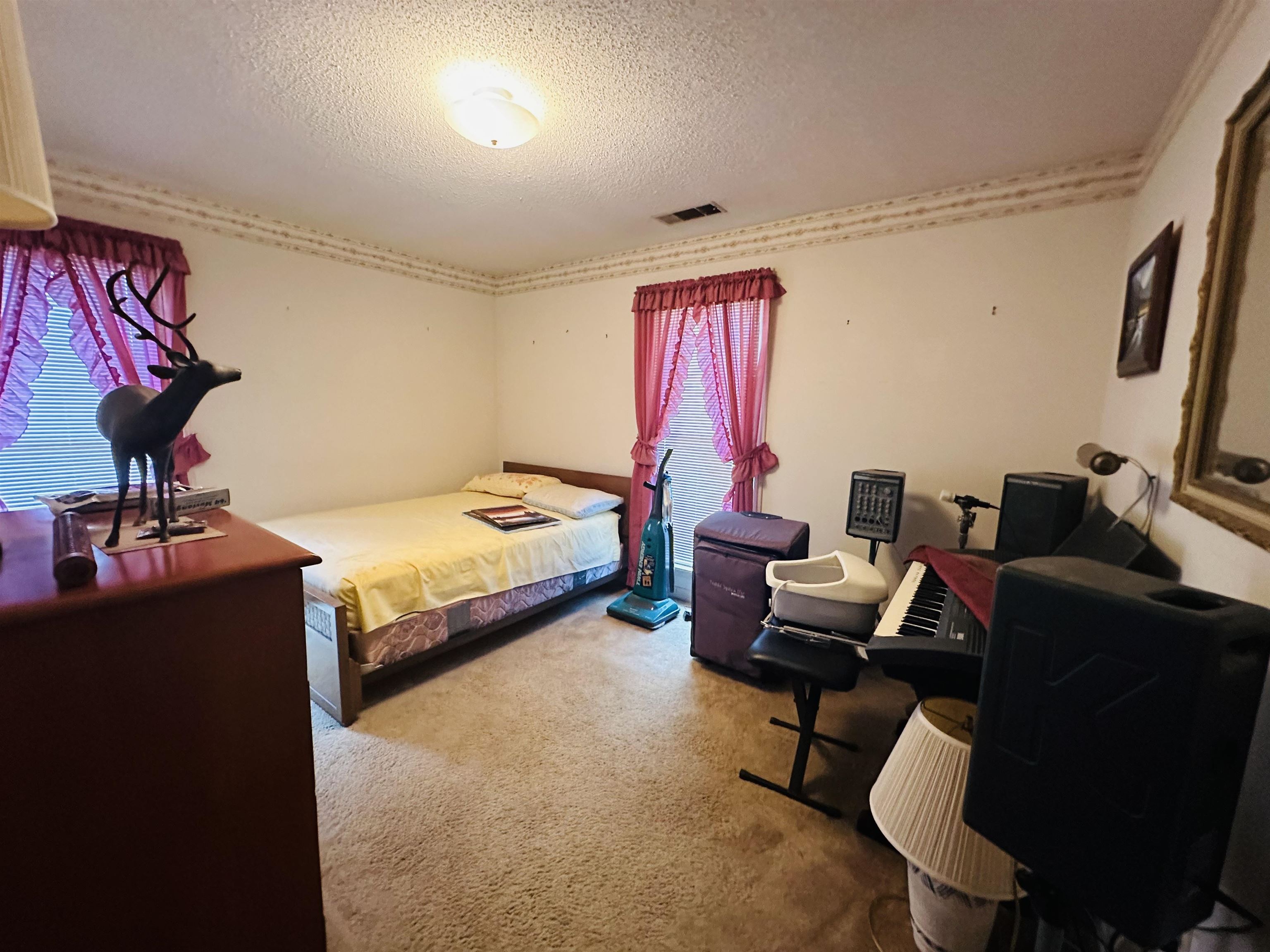 Carpeted bedroom featuring a textured ceiling