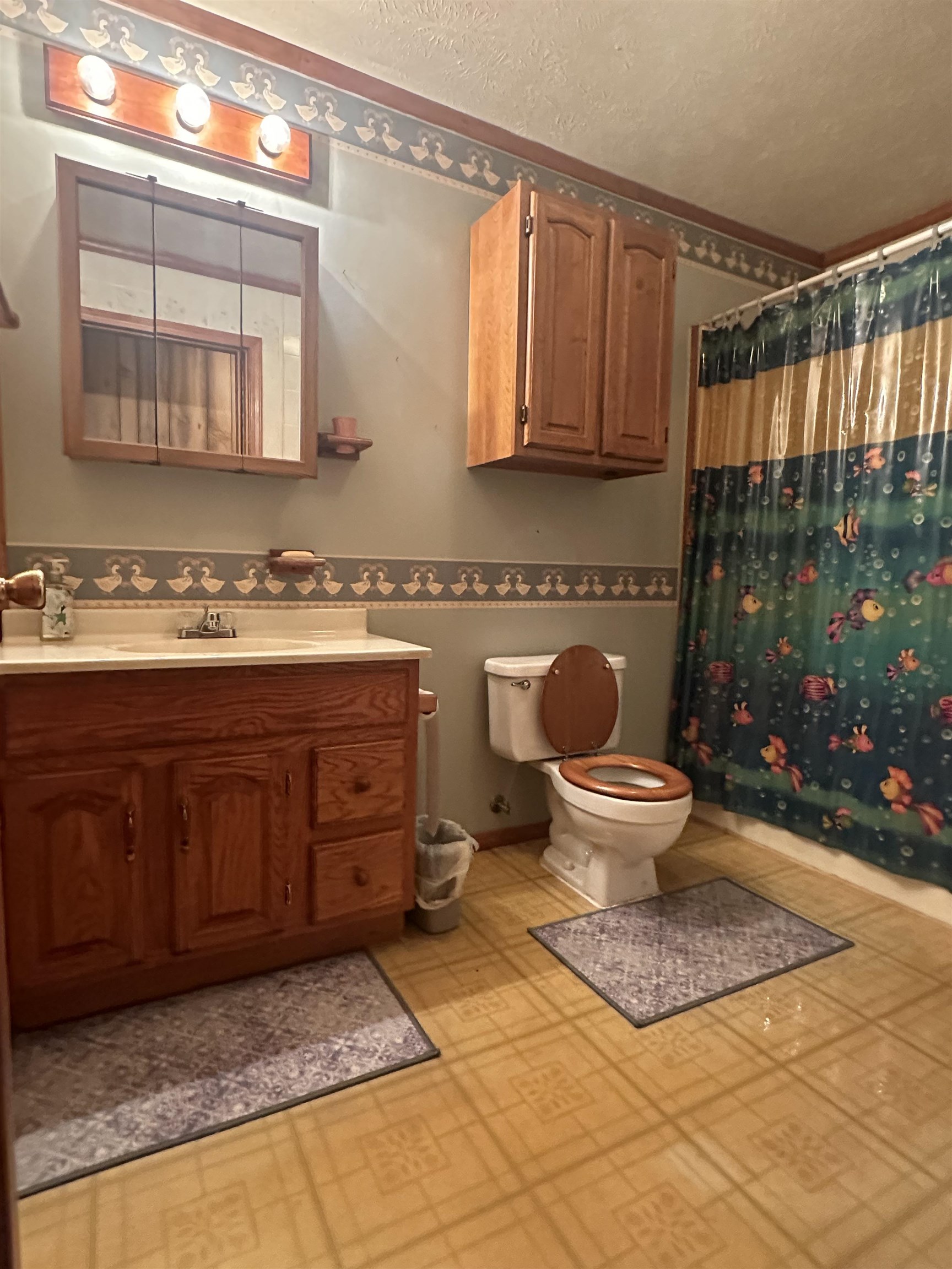 Bathroom with walk in shower, vanity, and toilet