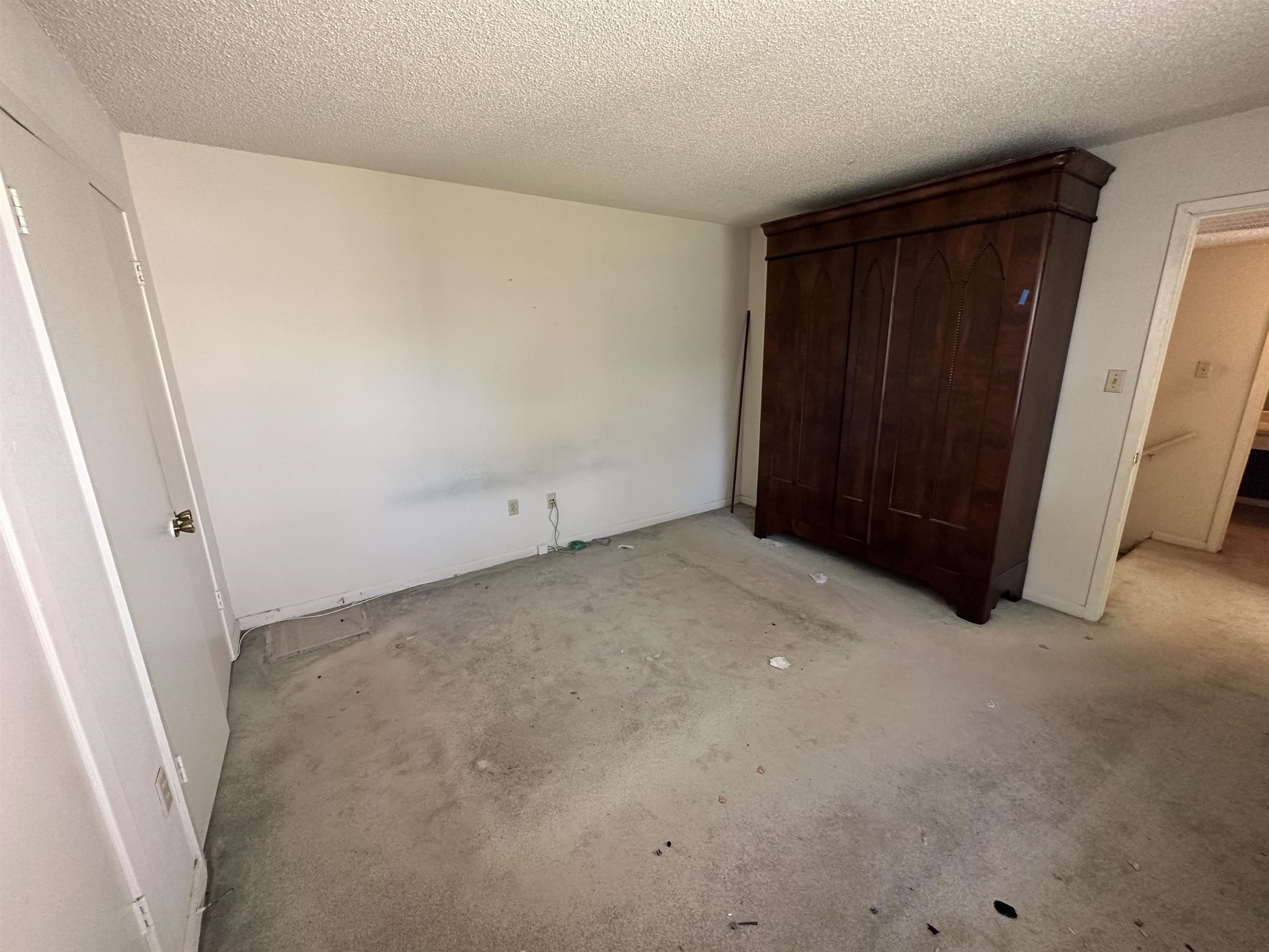 Unfurnished bedroom featuring a textured ceiling