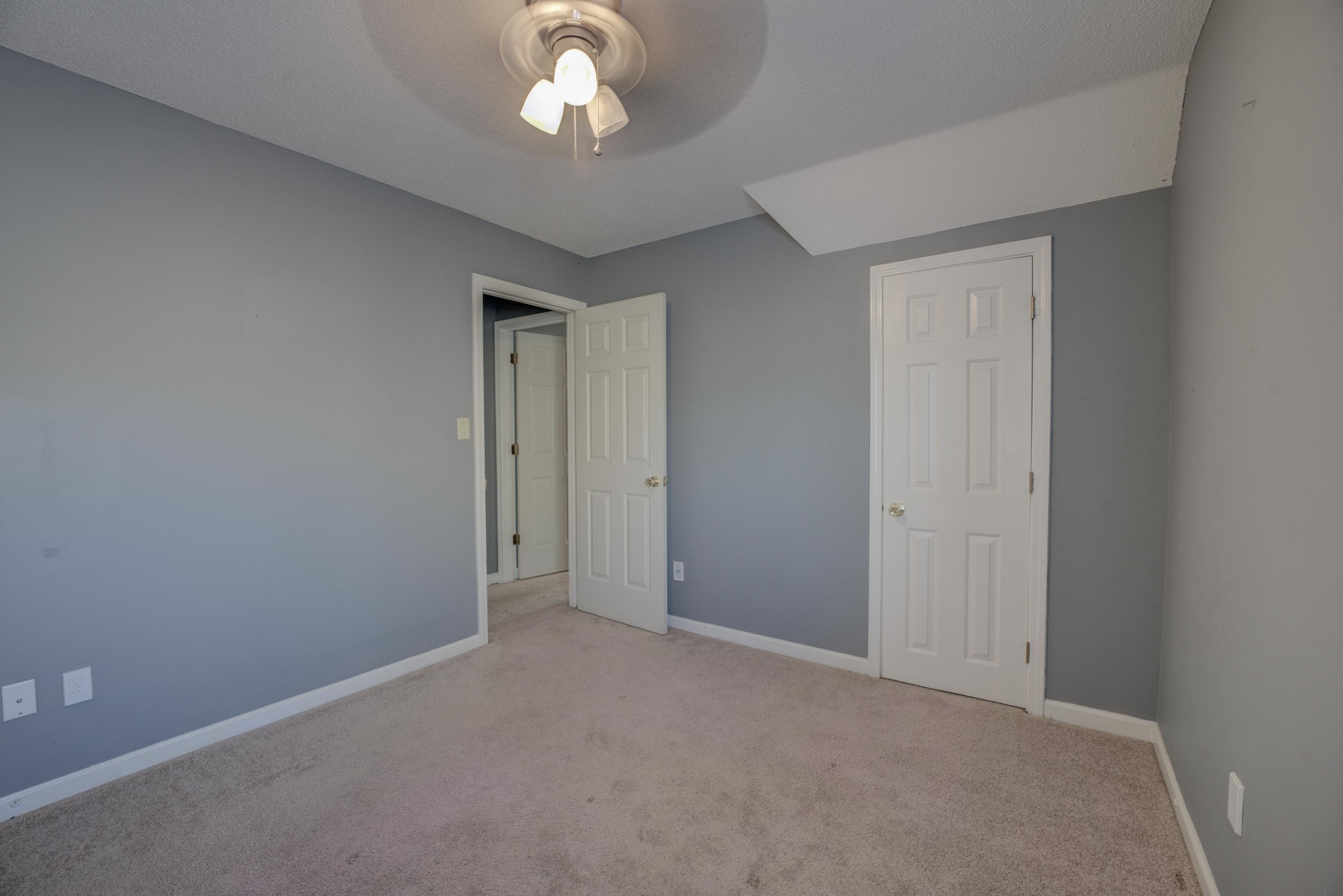 Unfurnished bedroom with ceiling fan, light colored carpet, and a closet