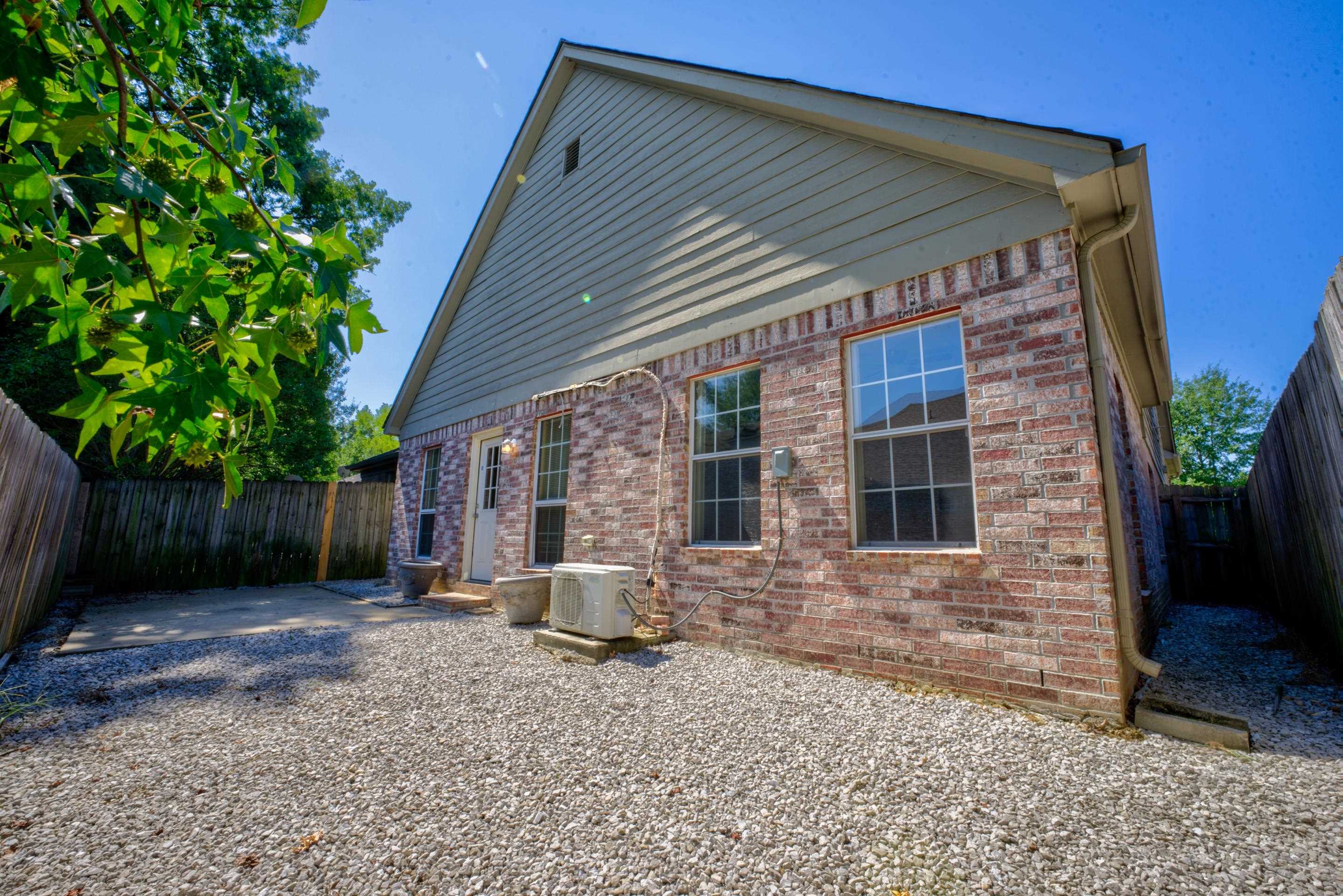 Back of property with ac unit and a patio area