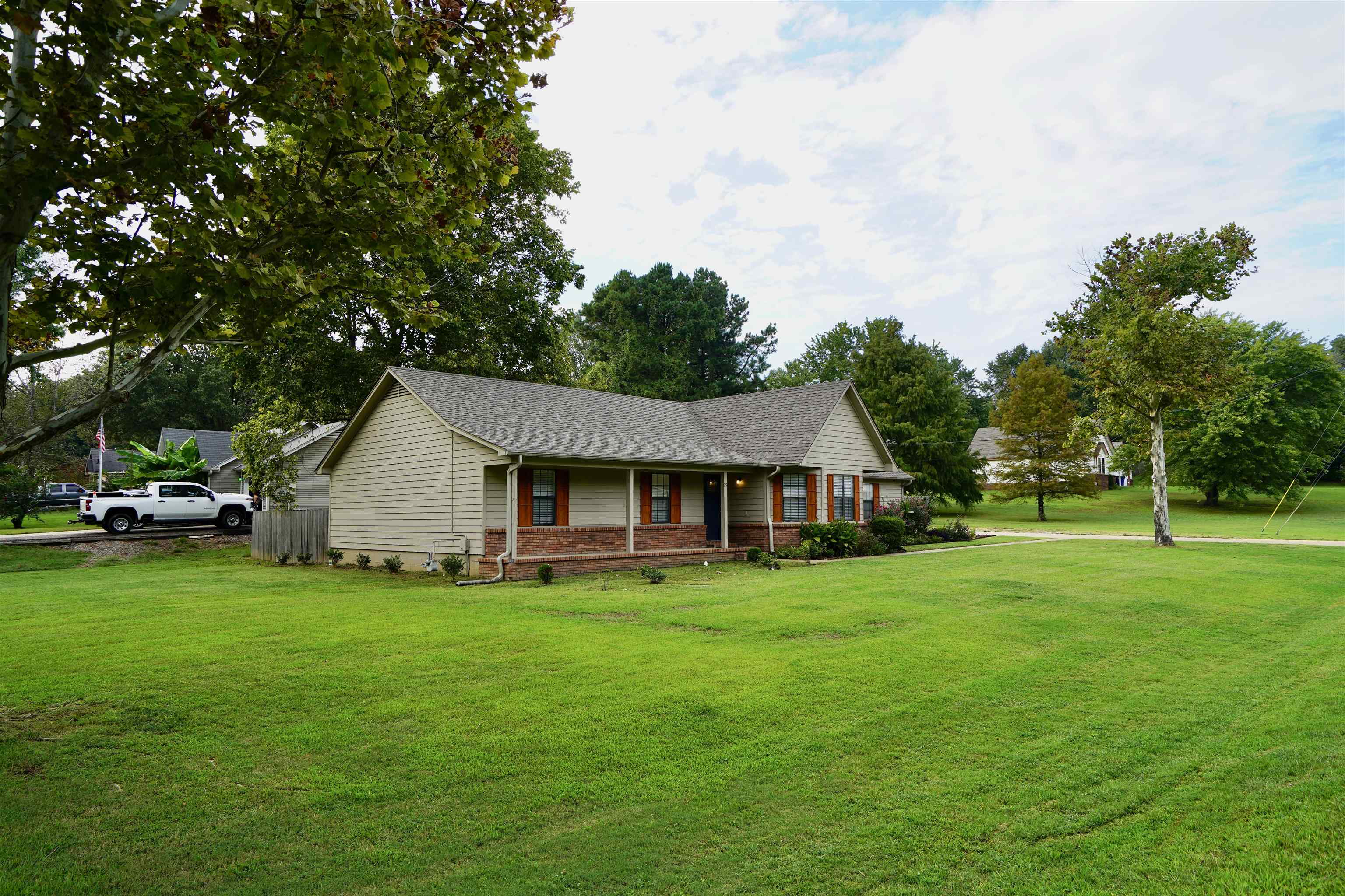 View of front of home featuring a front lawn and a porch