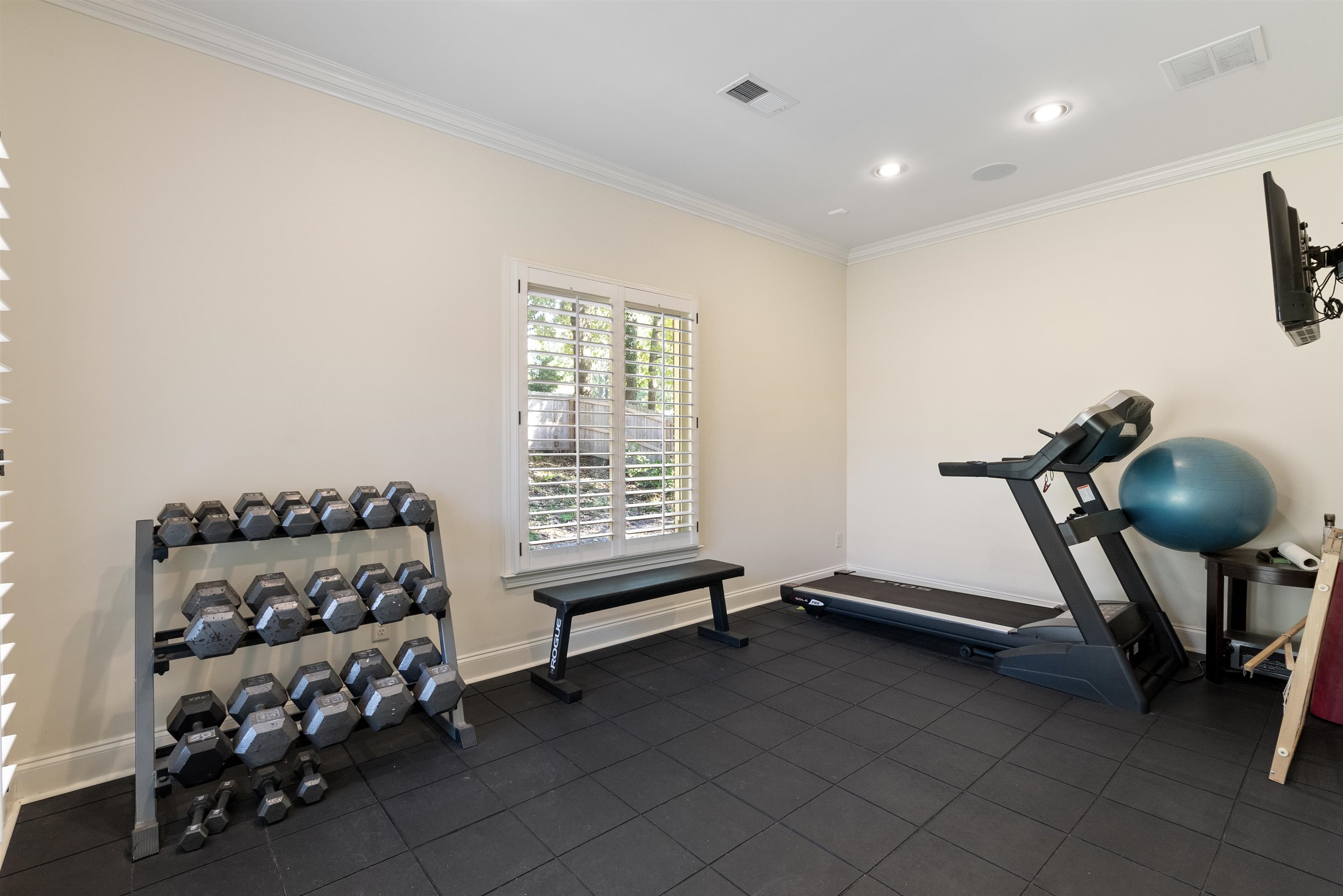 Exercise room featuring ornamental molding