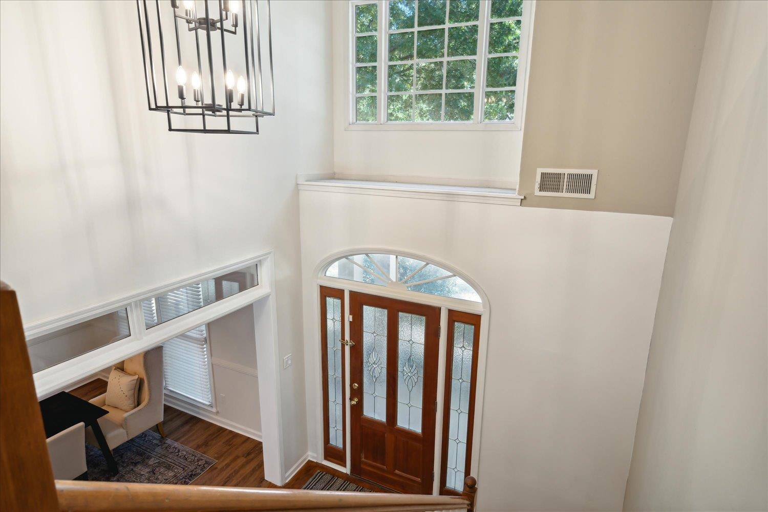 Entrance foyer featuring a chandelier and dark hardwood / wood-style floors