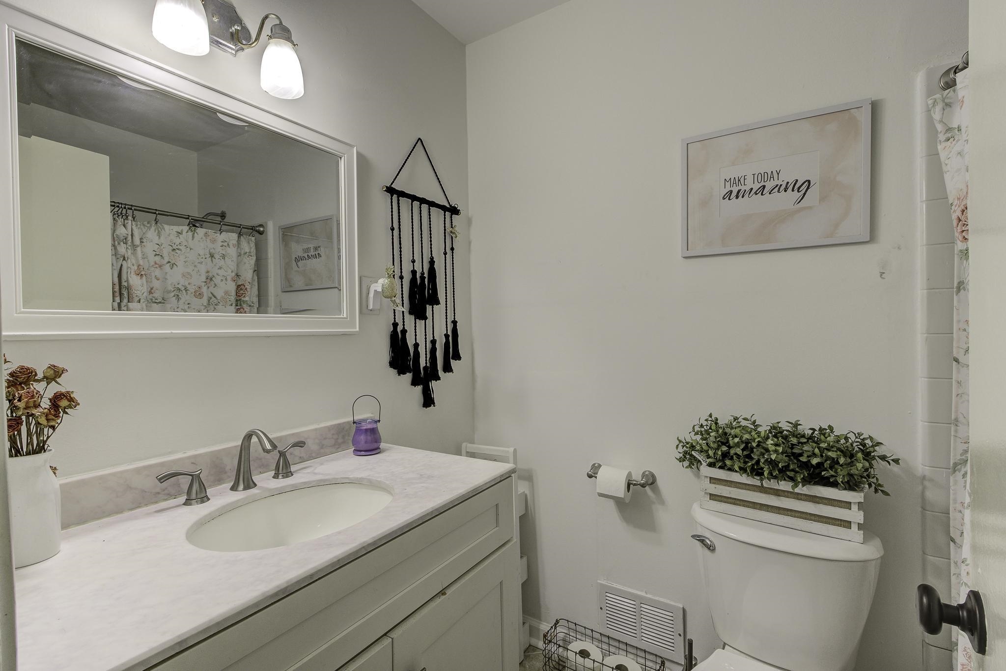 The guest bath has been nicely updated and offers a single vanity, neutral paint color and a tub/shower combo.  This bathroom is convenient to the guest bedrooms and entertainment areas of the home.