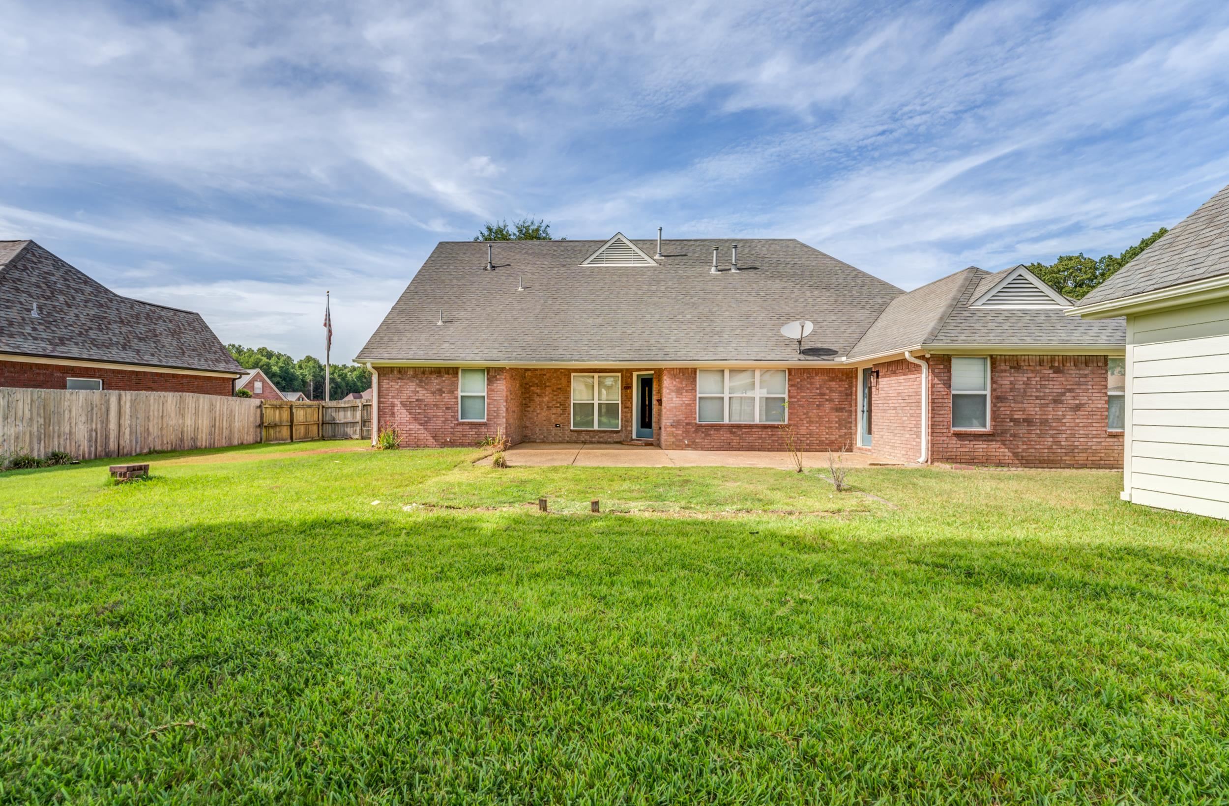 Back of property with a patio area and a lawn