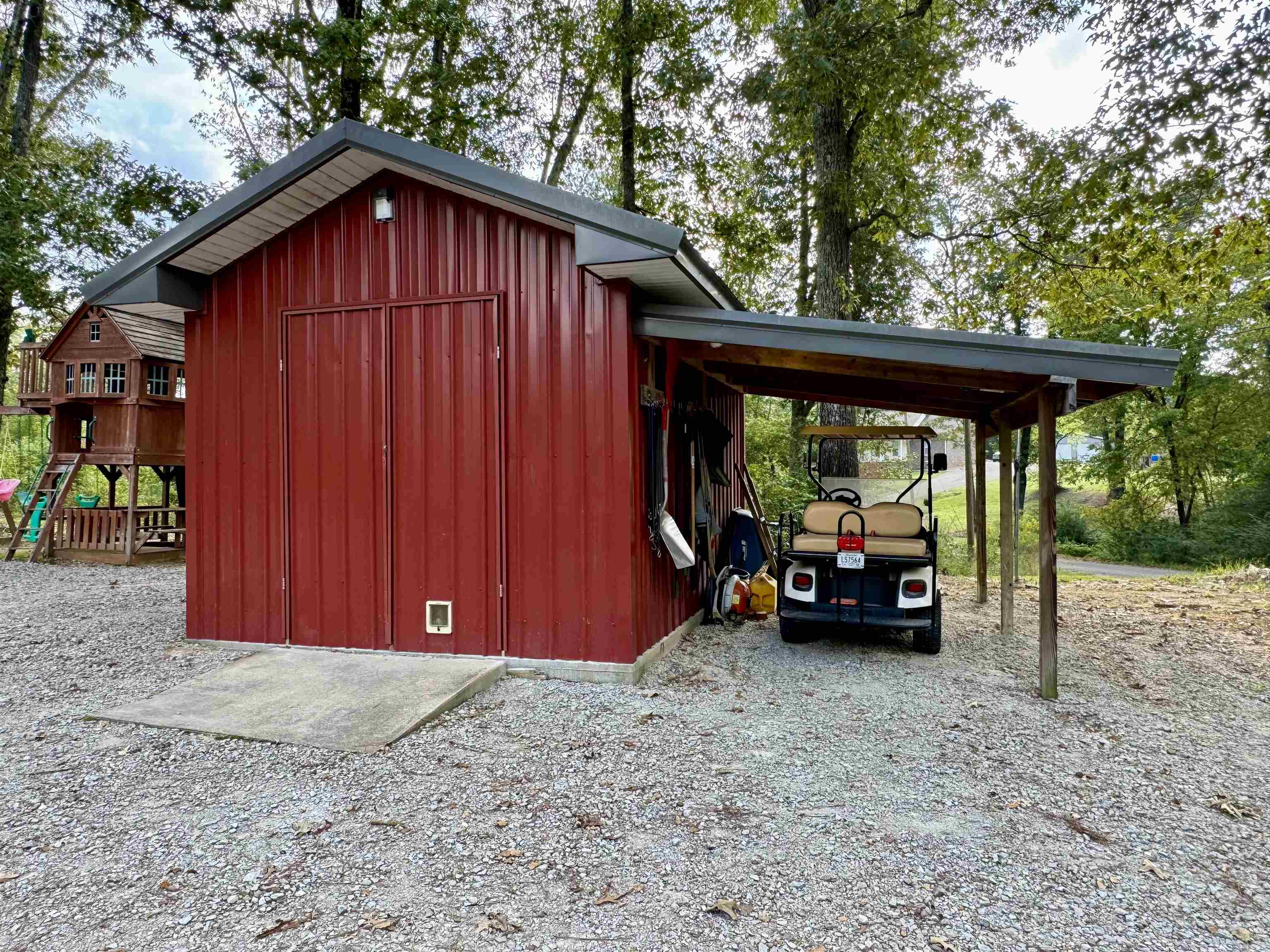 View of outbuilding featuring a carport