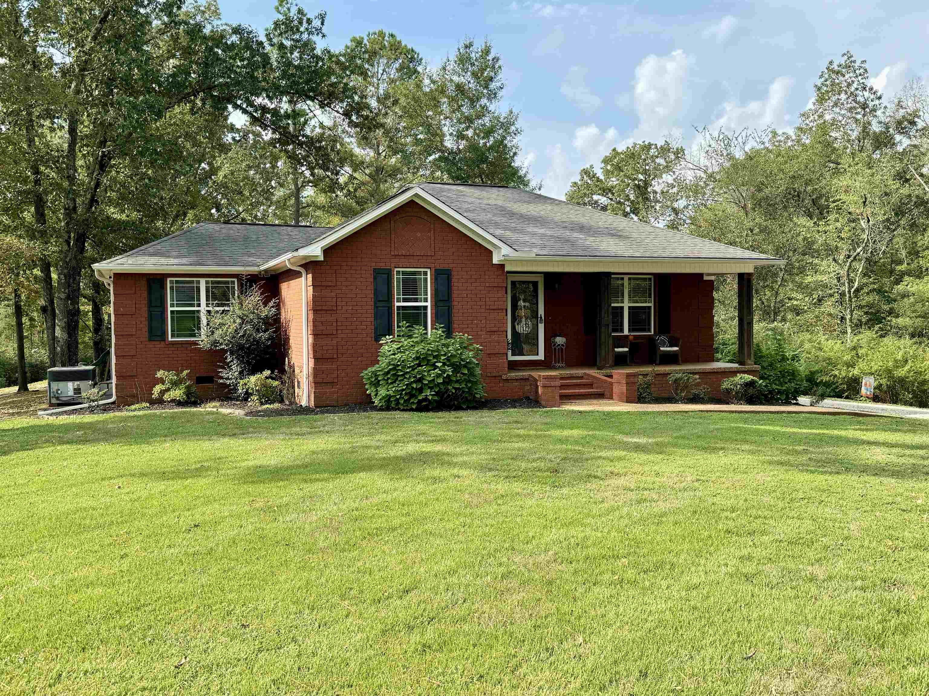 Ranch-style house with a front yard and a porch