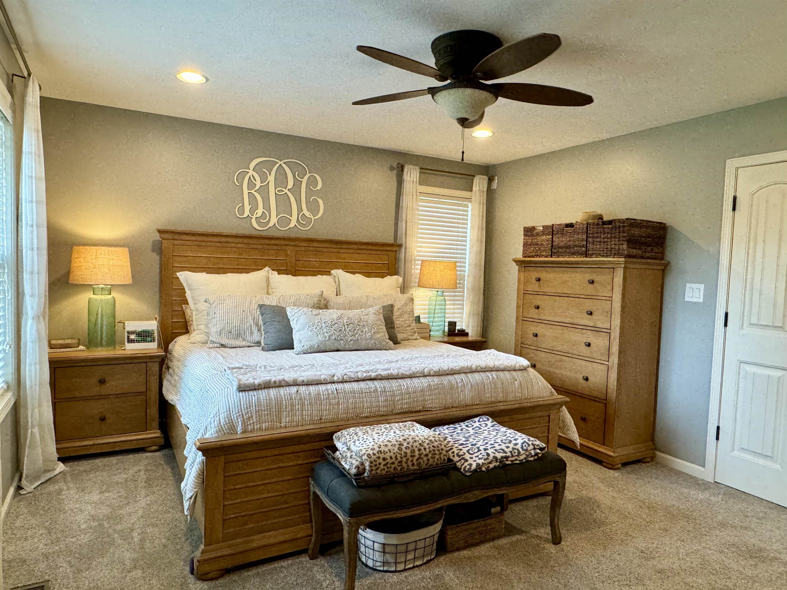 Bedroom with ceiling fan and light carpet