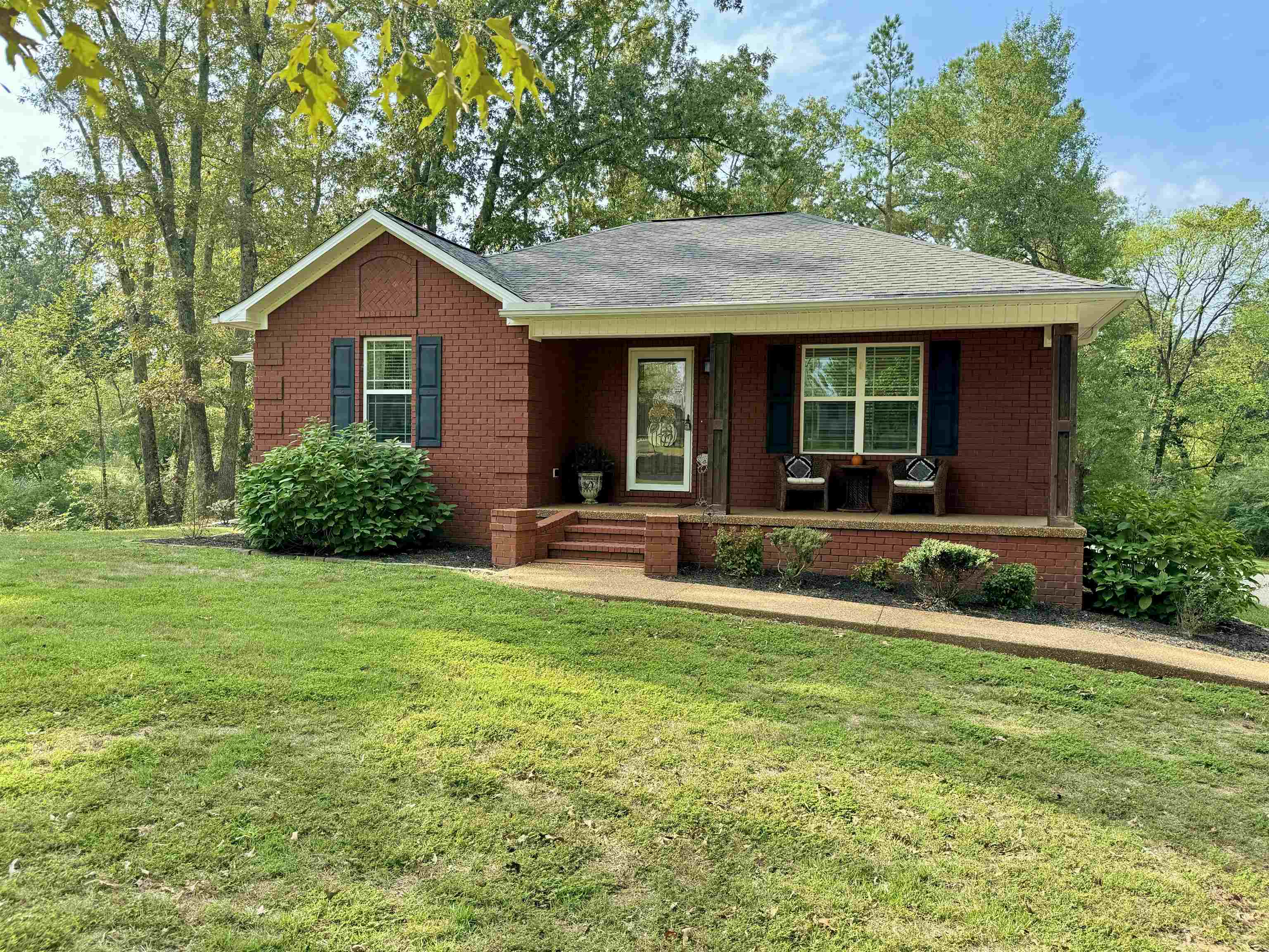 Single story home with a front yard and a porch