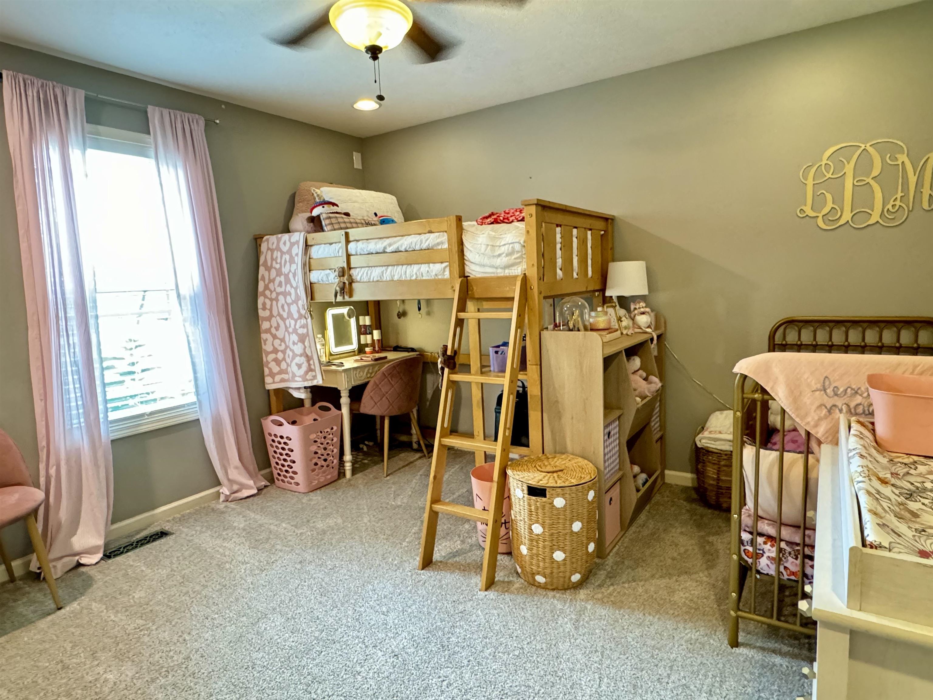 Bedroom with ceiling fan, carpet flooring, and multiple windows