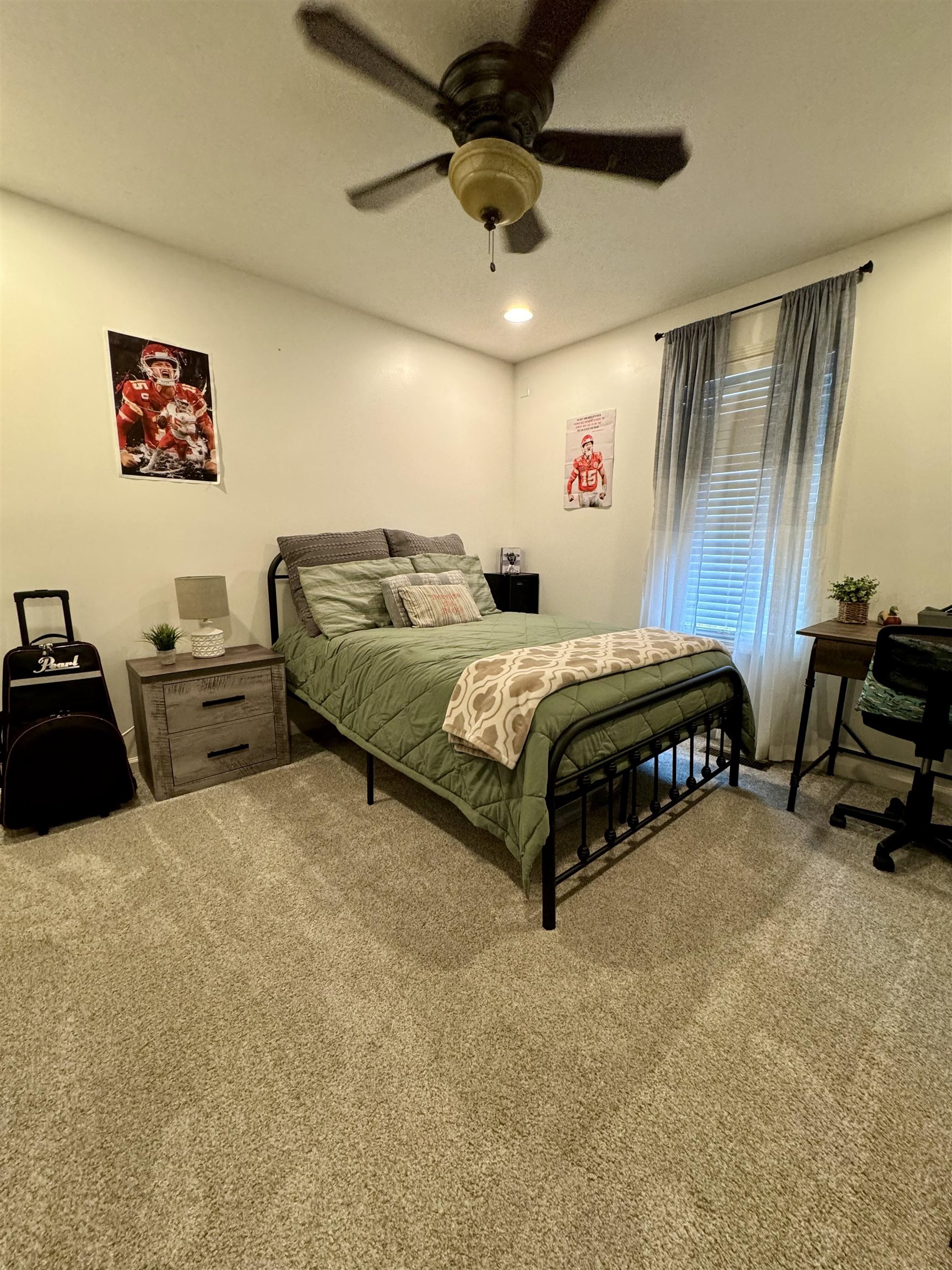 Bedroom with ceiling fan and carpet flooring