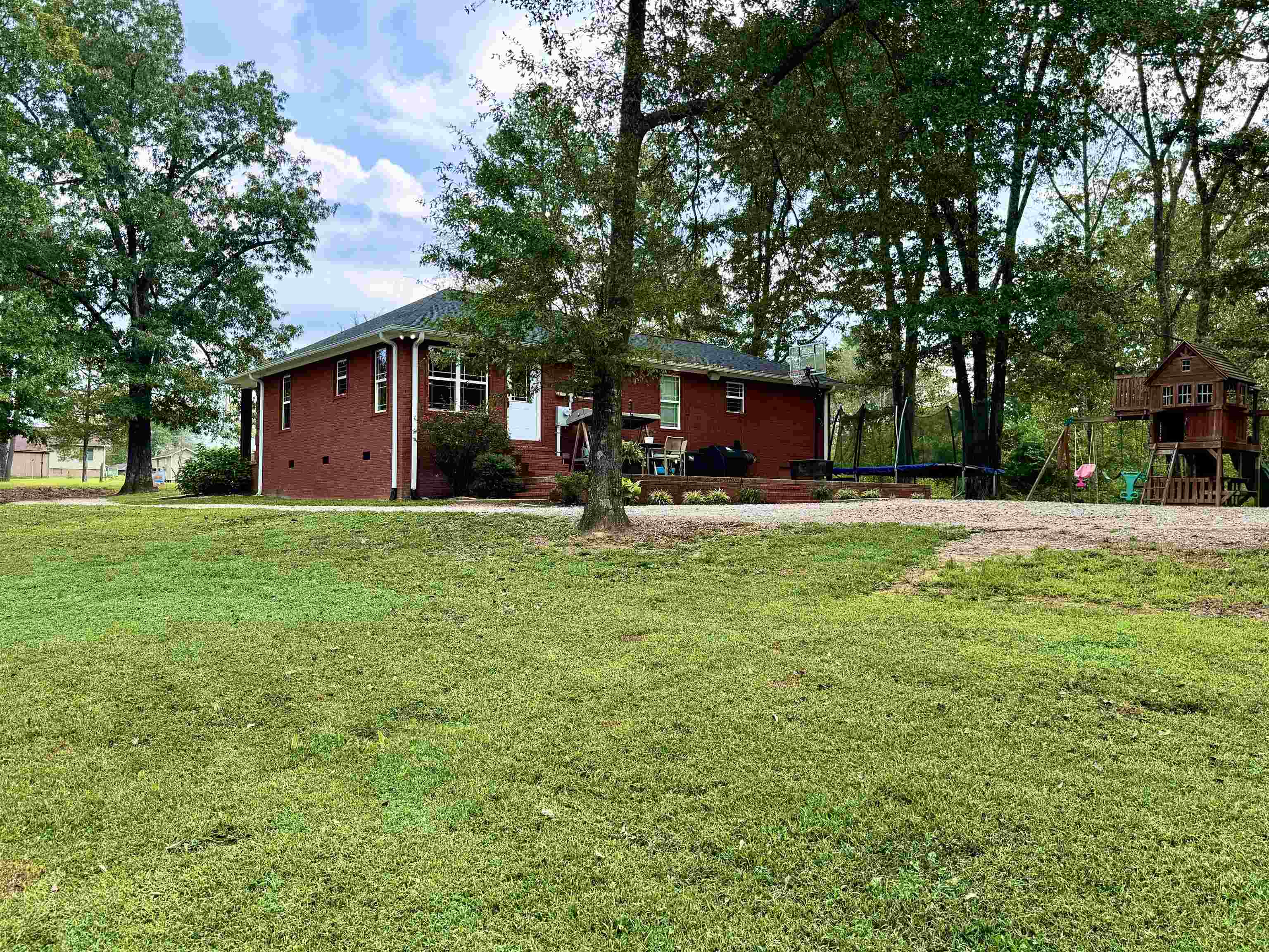 Exterior space with a playground and a front lawn