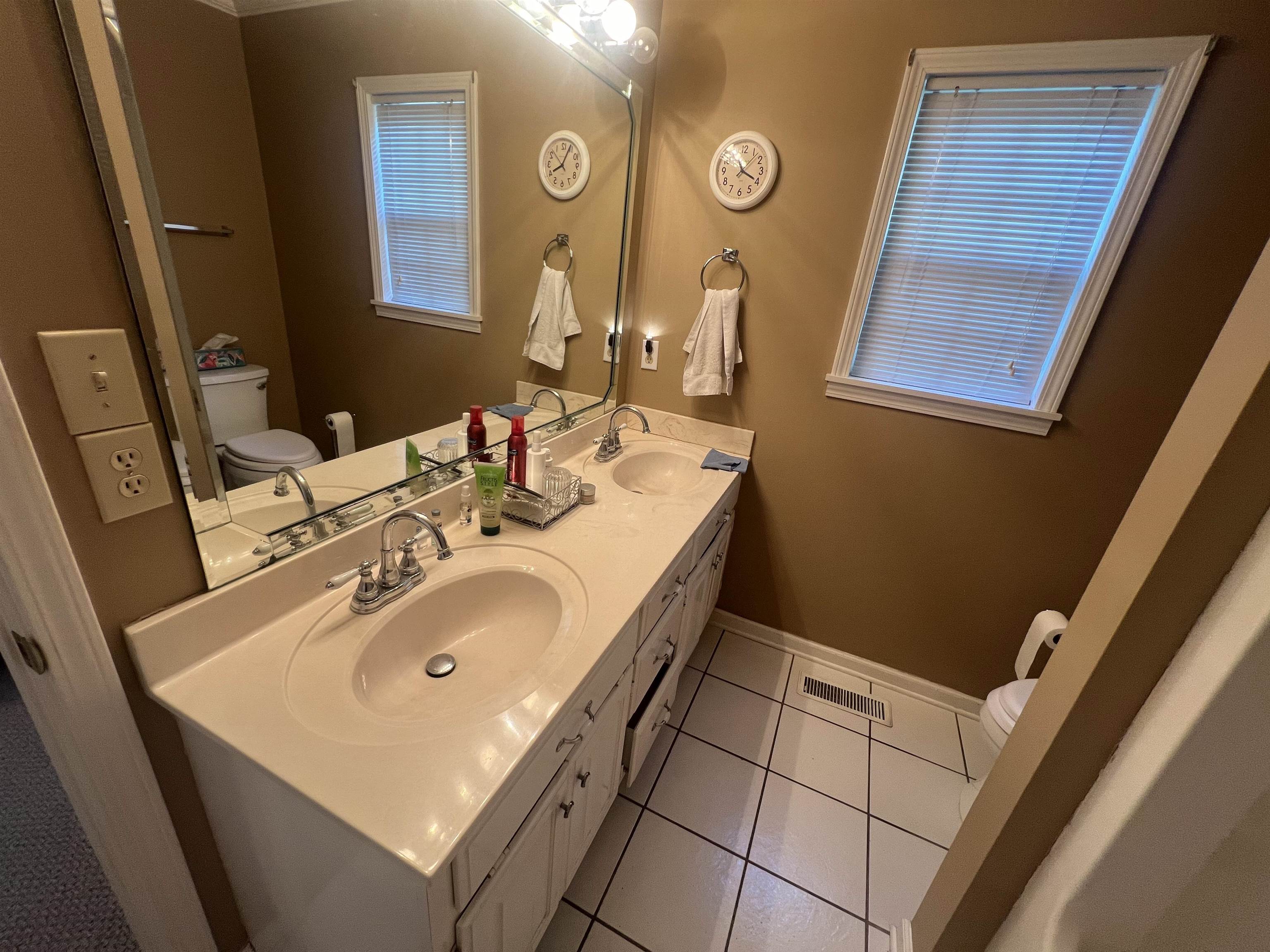 Bathroom featuring tile patterned flooring, vanity, and toilet