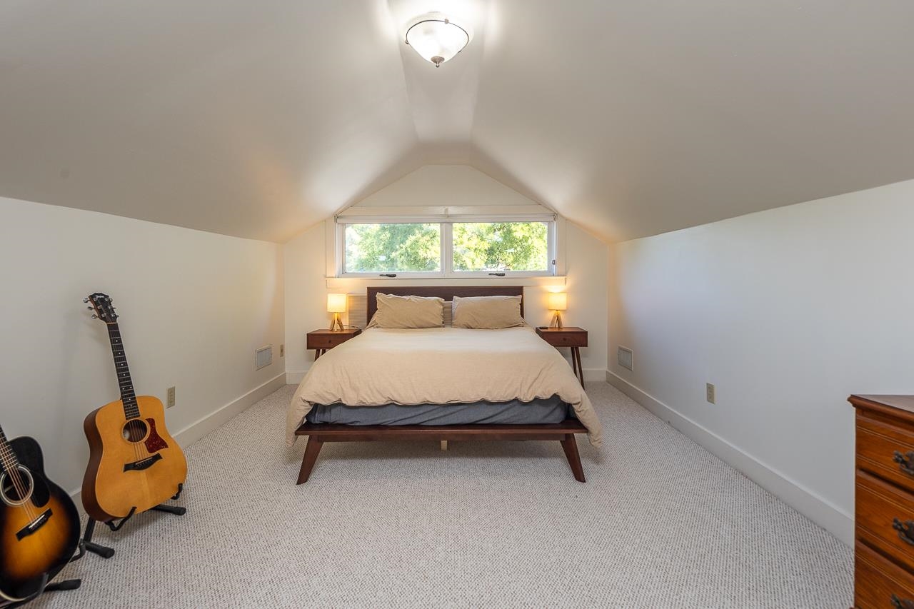 Carpeted bedroom with lofted ceiling