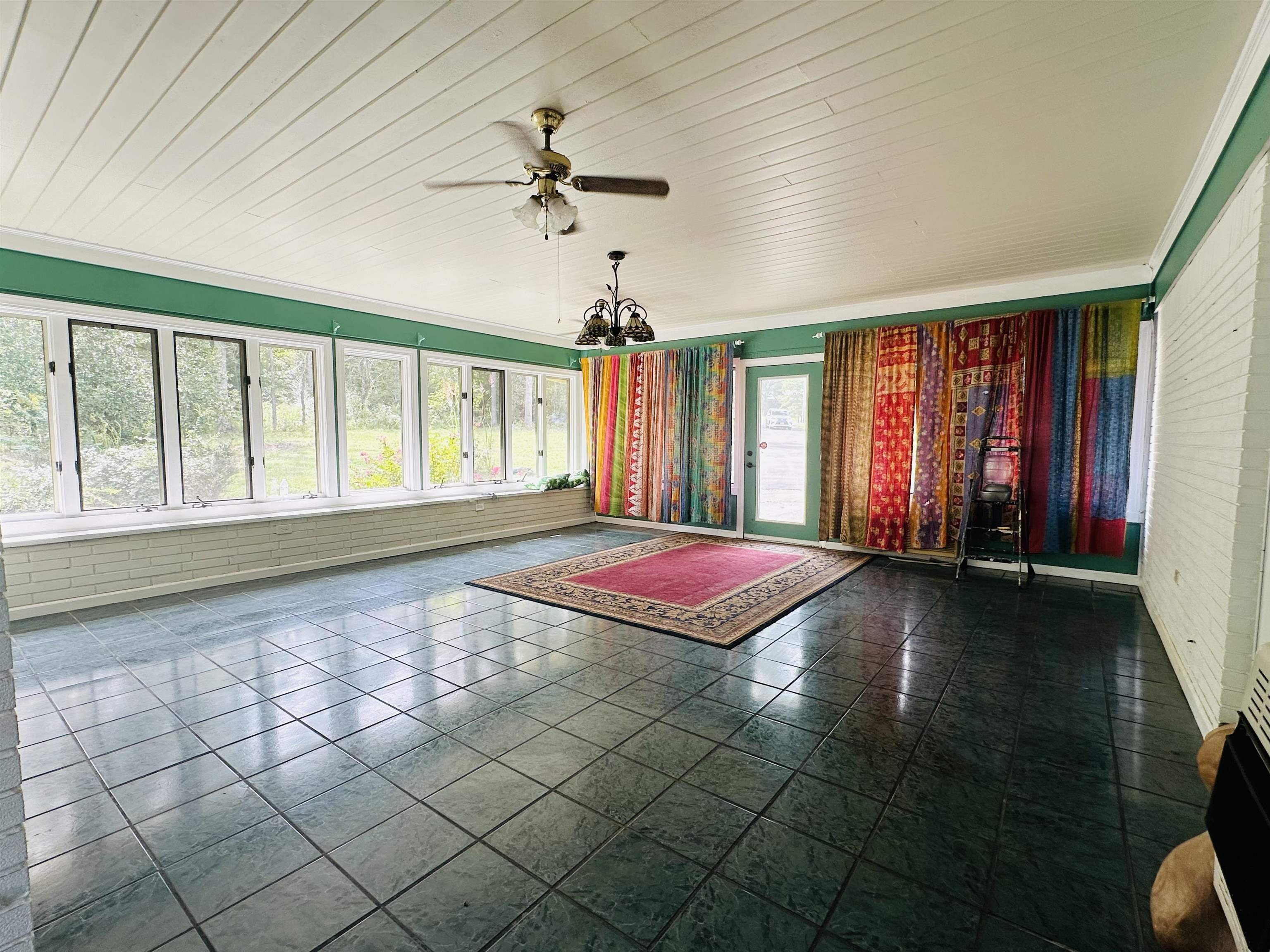 Interior space with wood ceiling, a wealth of natural light, and ceiling fan