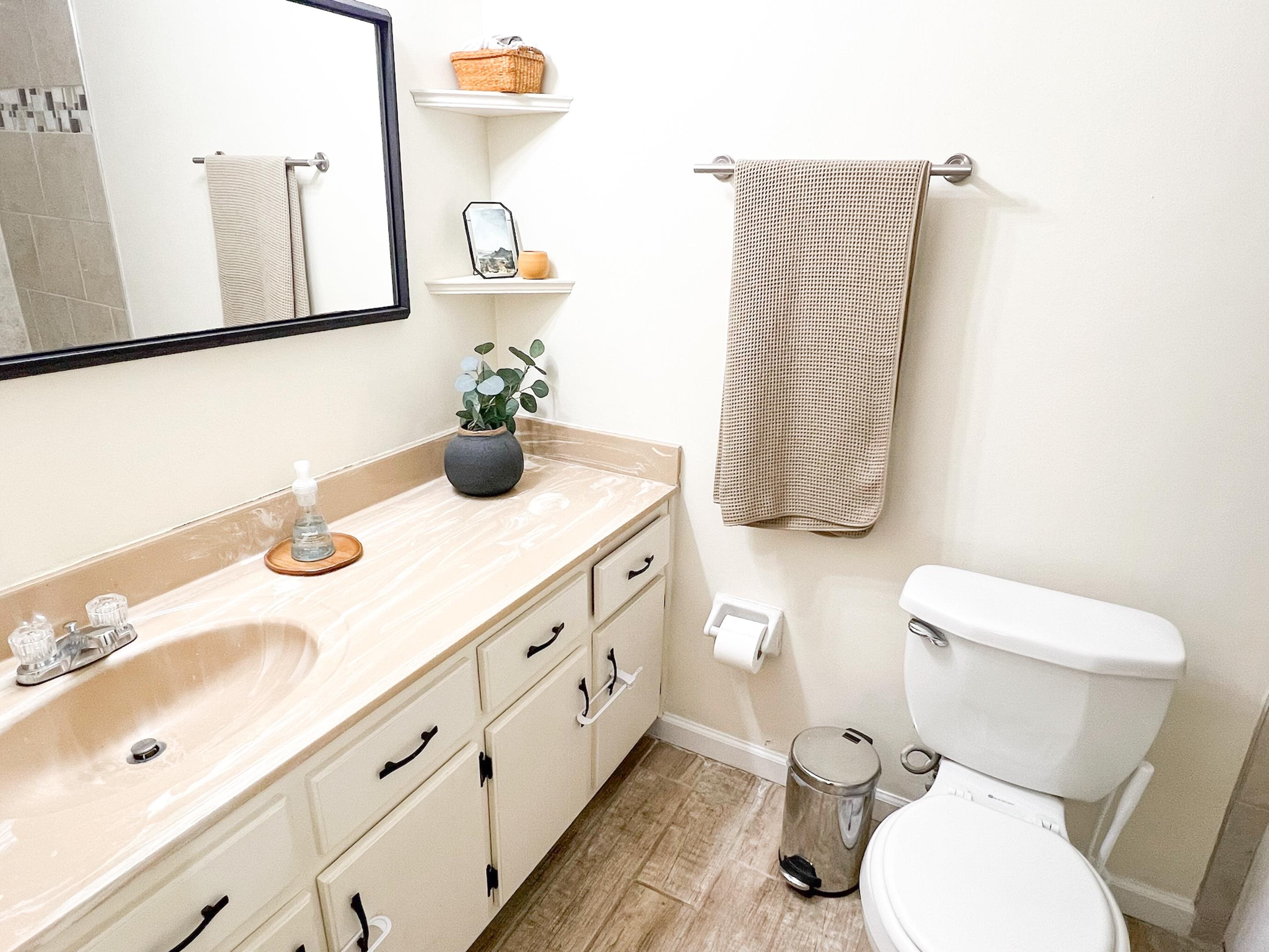 Bathroom with hardwood / wood-style floors, vanity, and toilet