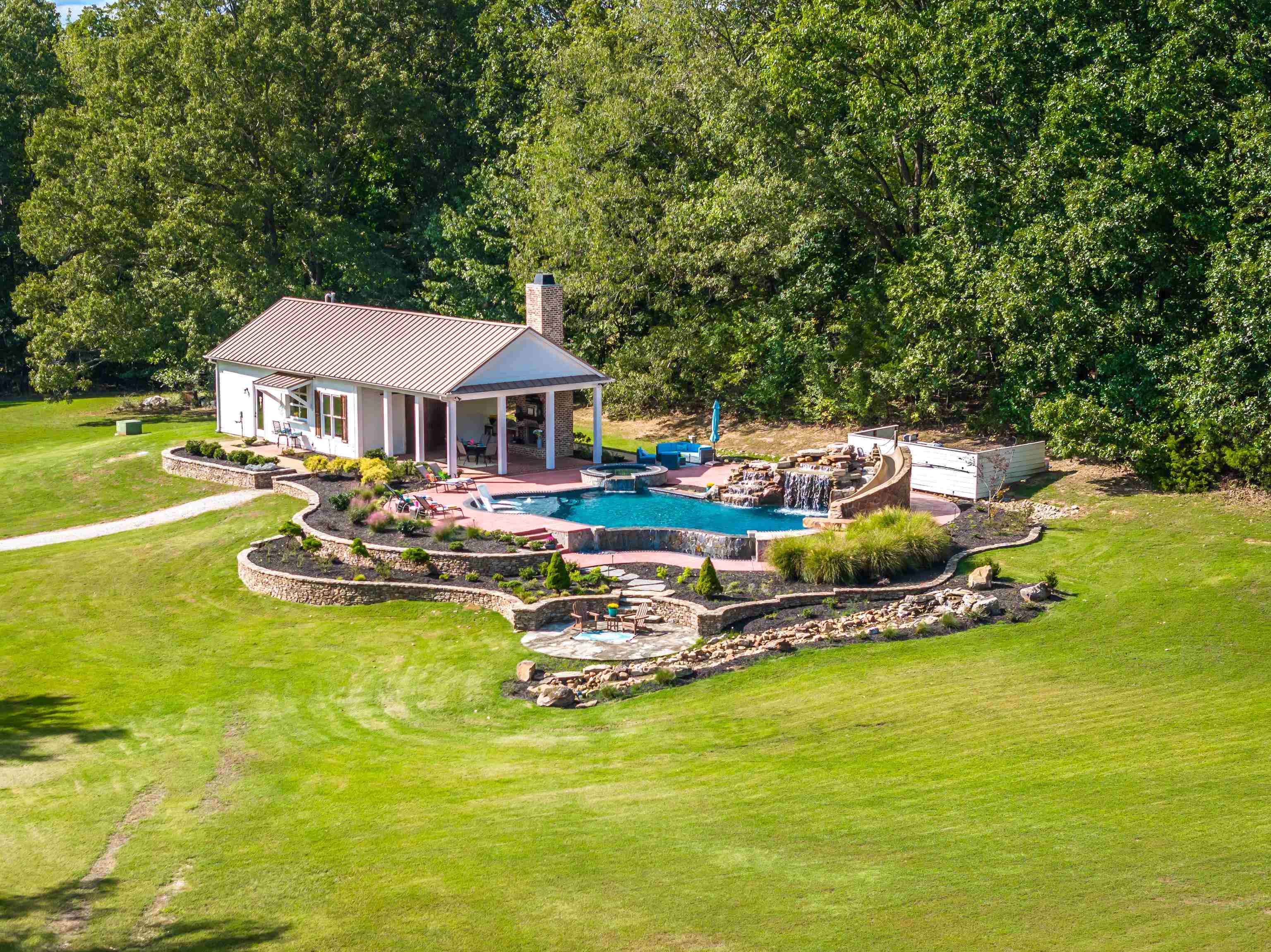 Aerial View of the private Luxurious Salt Water Pool and Pool house designed to provide a vacation-like experience for the lucky owner of this estate! Absolutely NO EXPENSE was spared when designing this oasis!