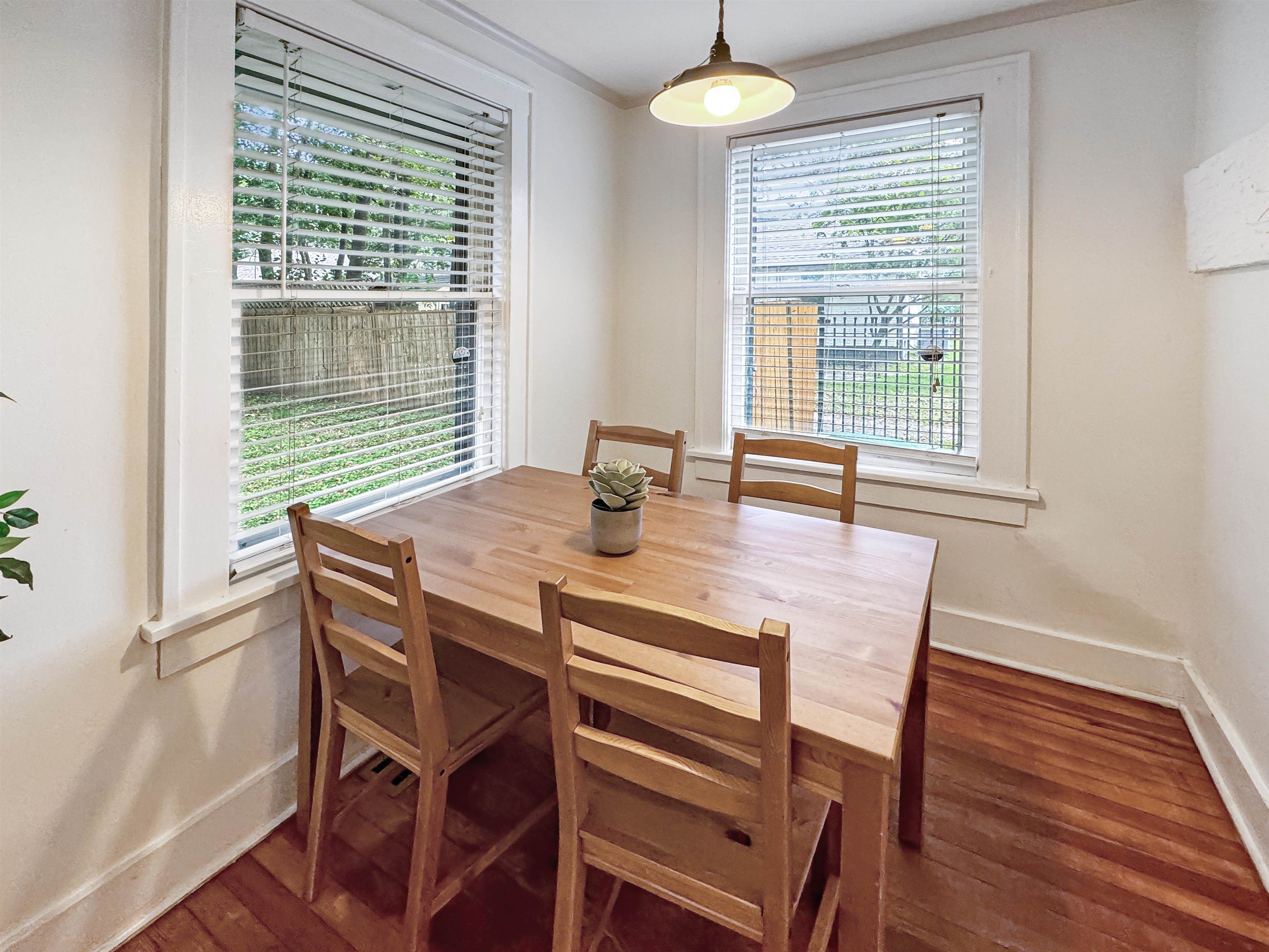 Dining space featuring ornamental molding and dark wood-type flooring