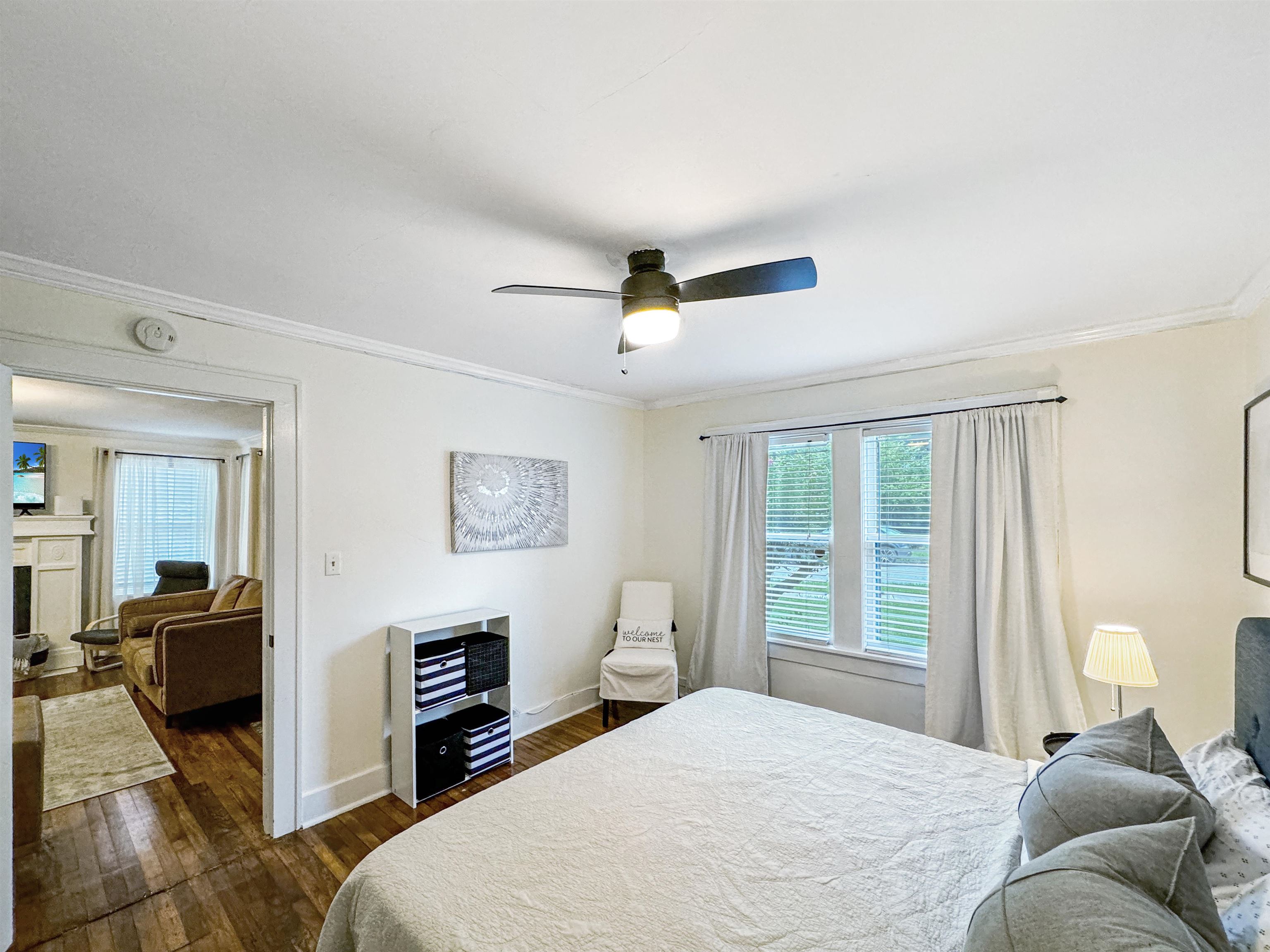 Bedroom with ornamental molding, ceiling fan, and dark wood-type flooring