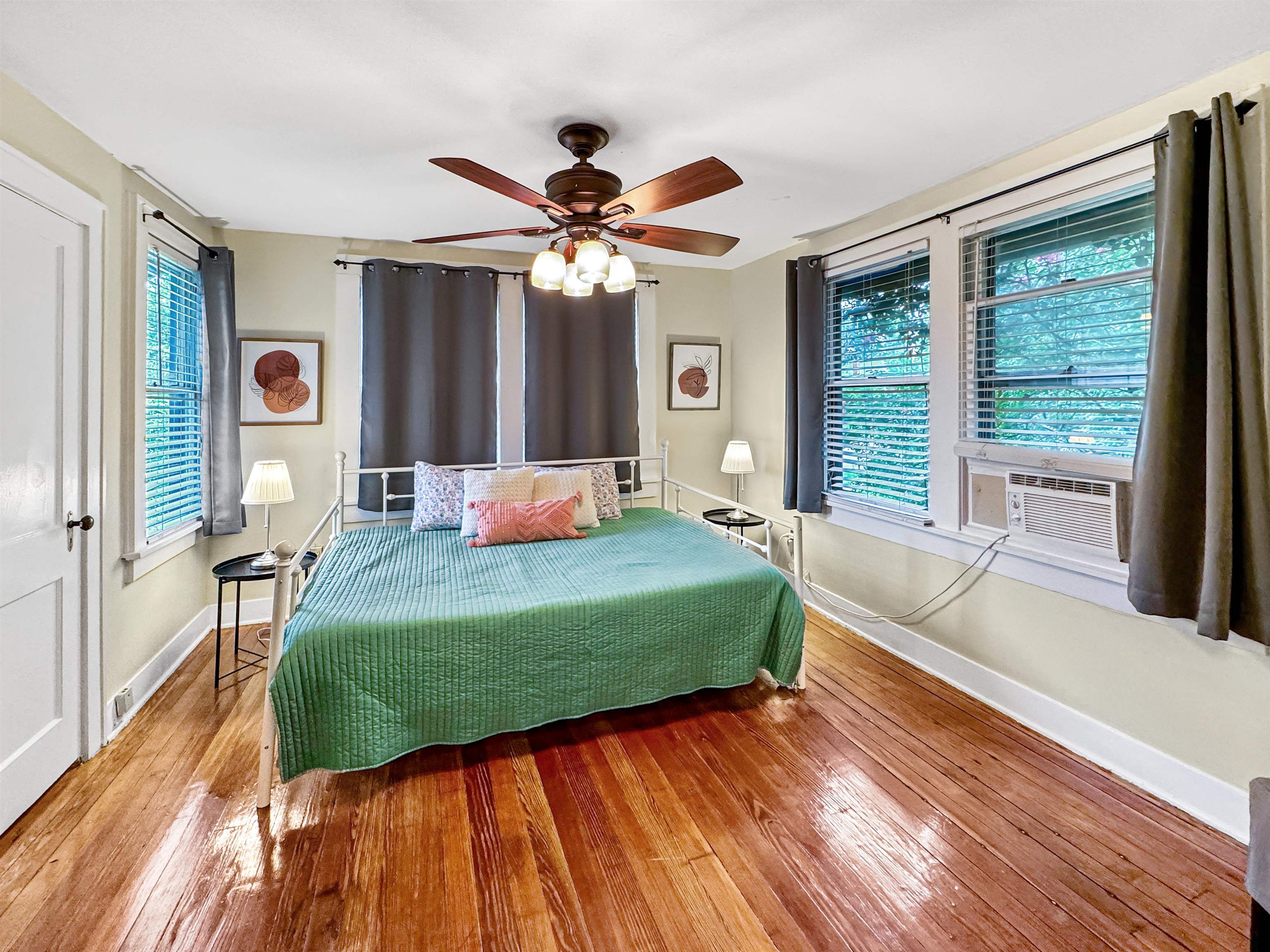 Bedroom featuring ceiling fan, cooling unit, and hardwood / wood-style flooring