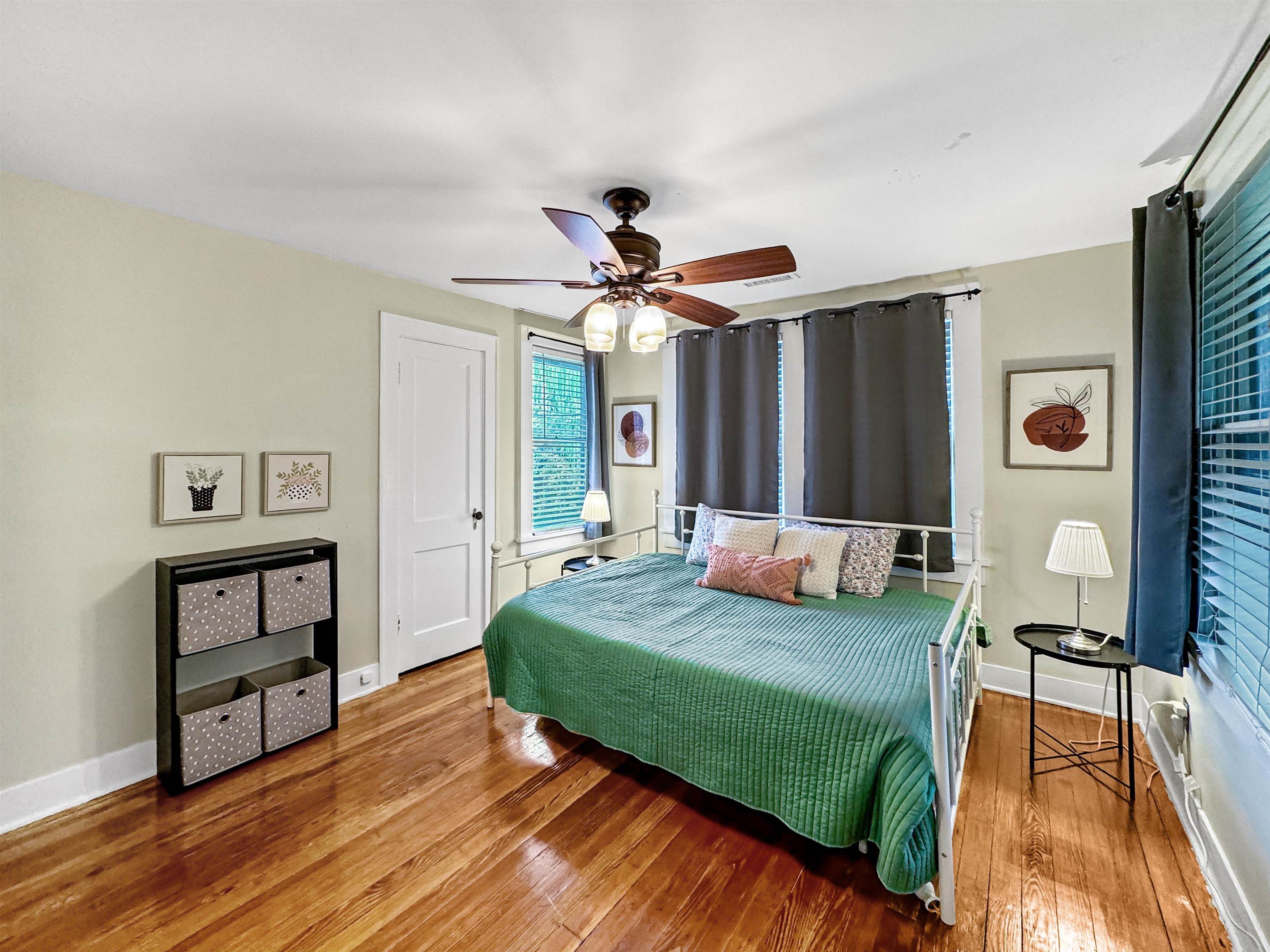Bedroom with ceiling fan and hardwood / wood-style floors