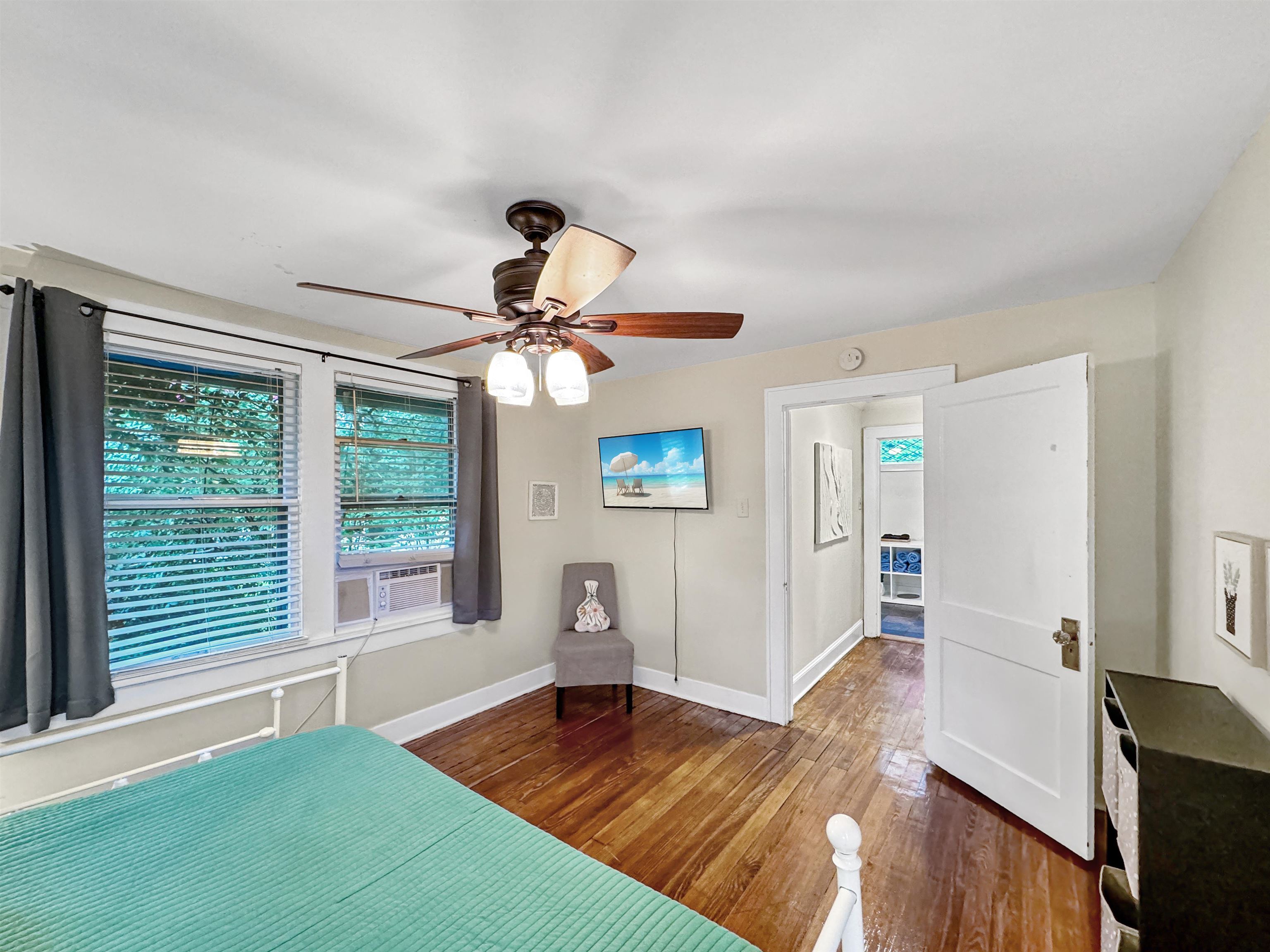 Unfurnished bedroom featuring dark hardwood / wood-style floors and ceiling fan