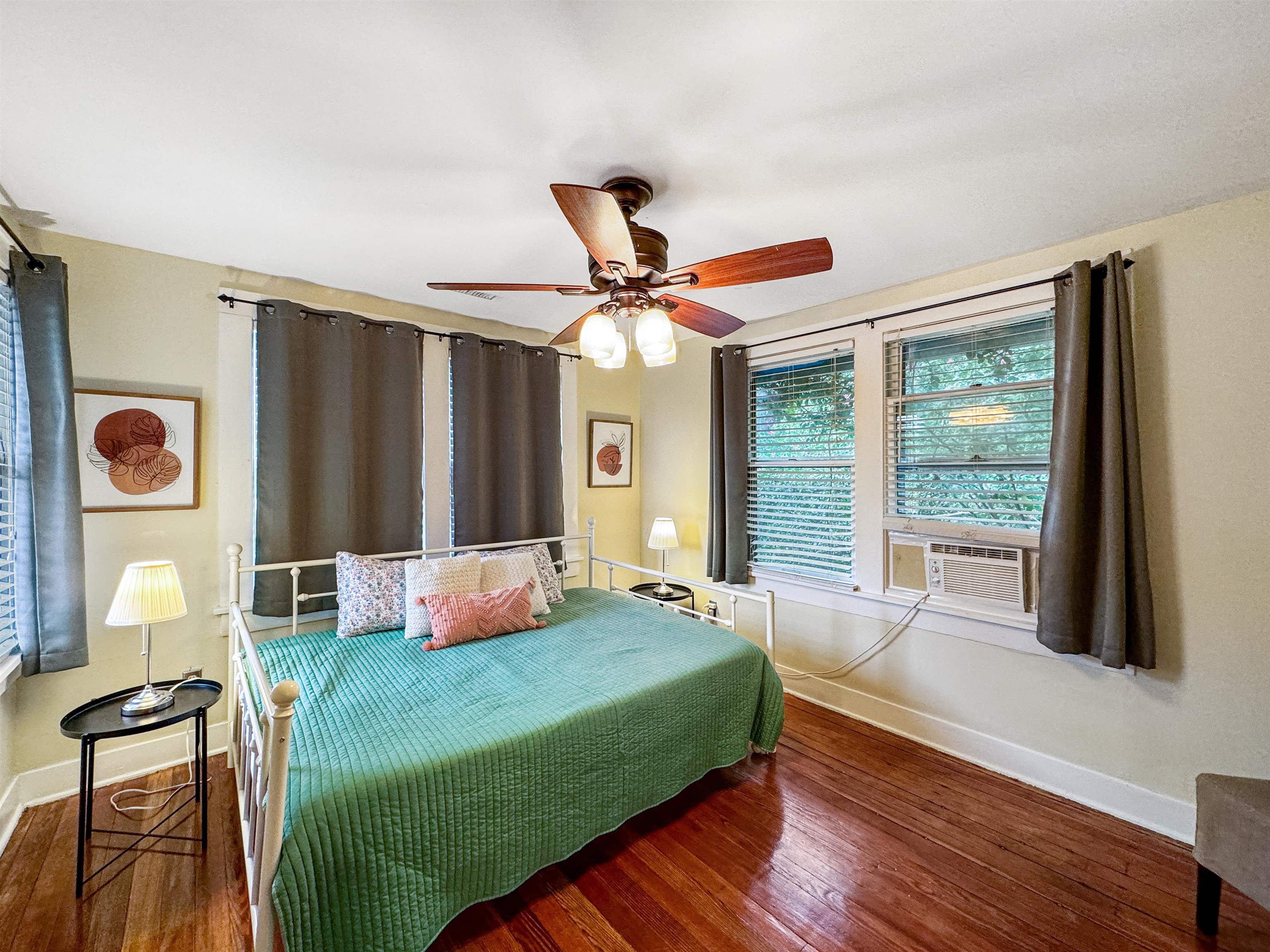 Bedroom featuring ceiling fan, cooling unit, and dark hardwood / wood-style flooring