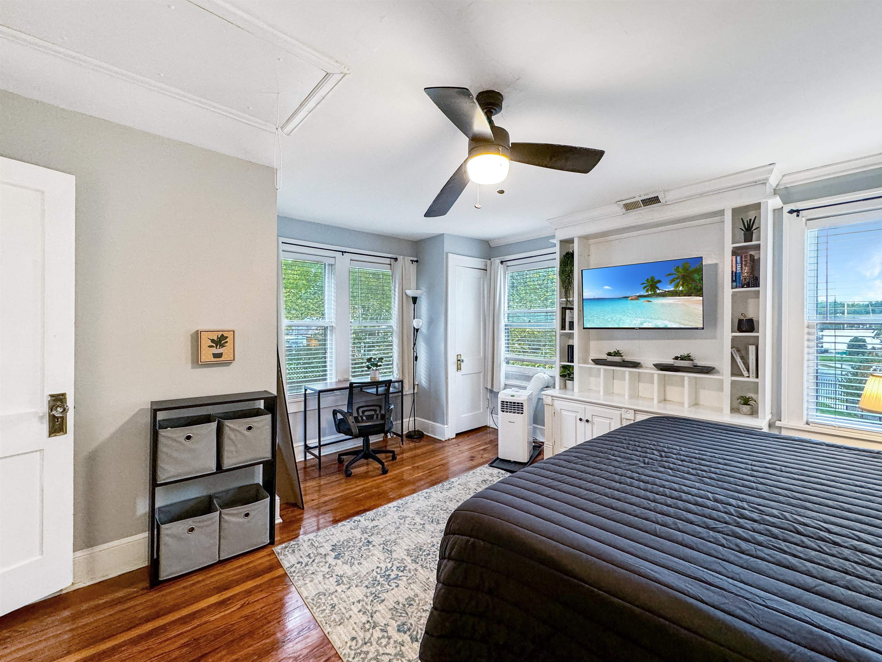 Bedroom featuring ceiling fan and dark wood-type flooring