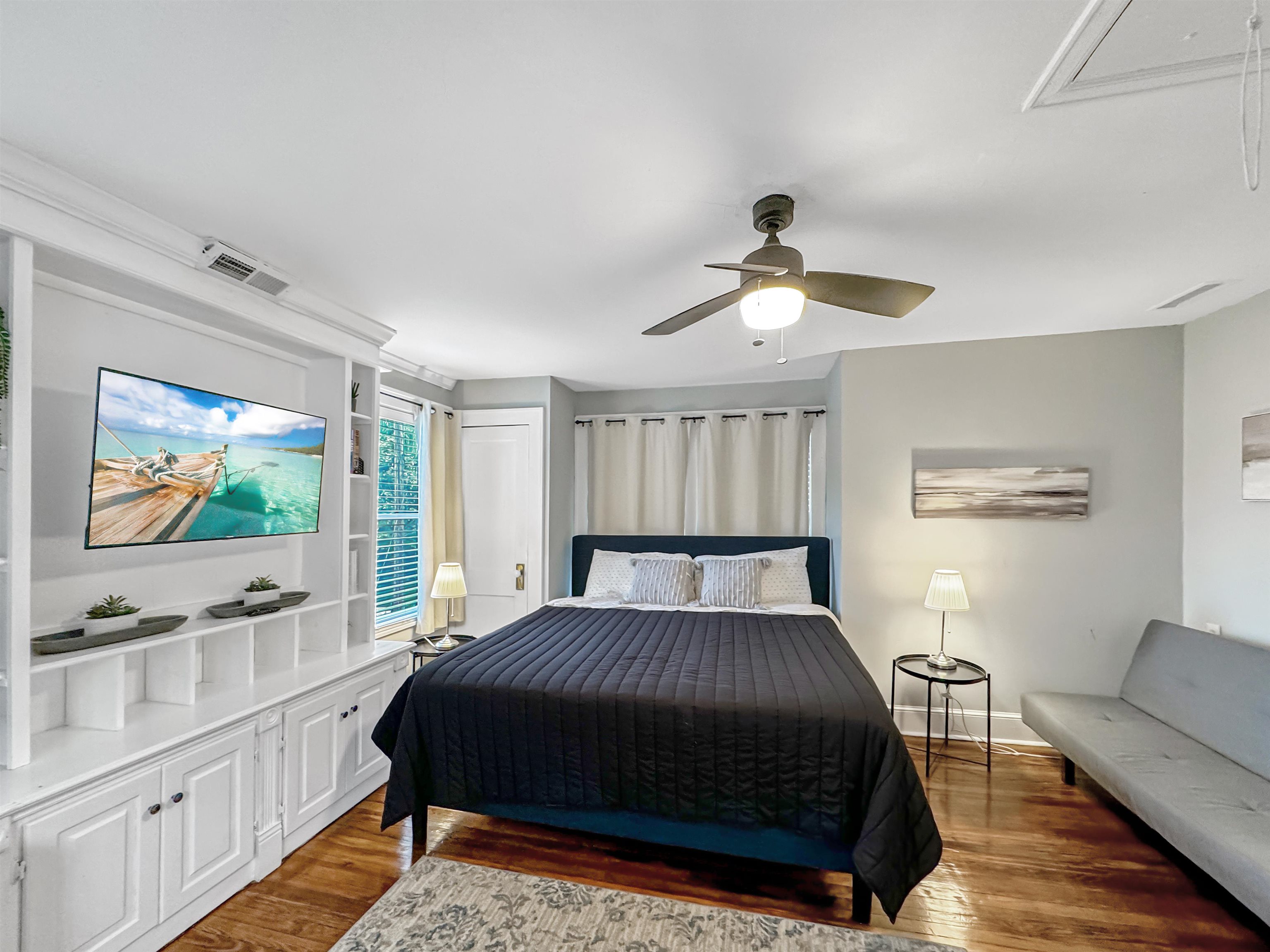 Bedroom featuring dark hardwood / wood-style flooring and ceiling fan